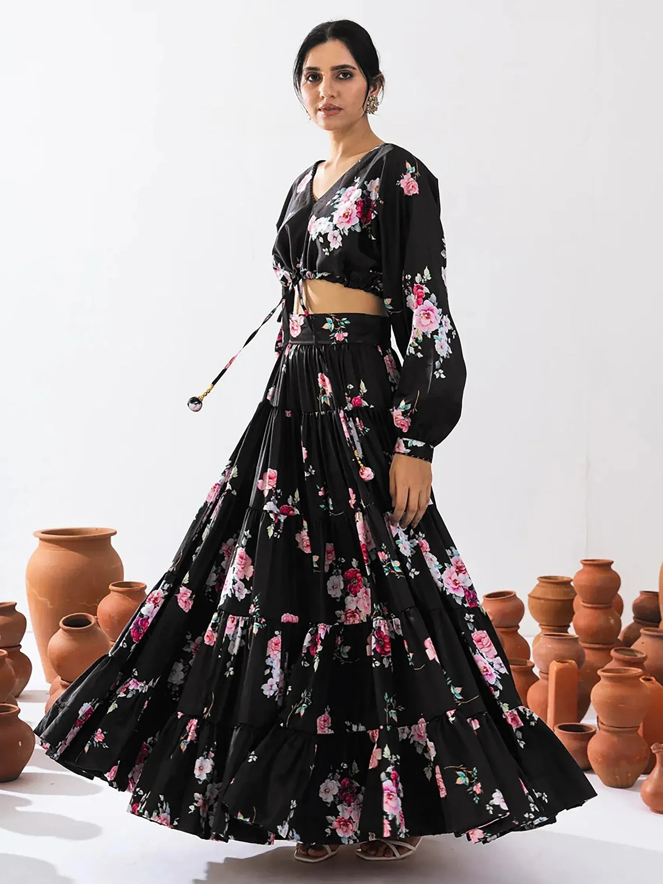 Black floral print lehenga choli with tiered skirt, perfect for ethnic occasions and festive wear.