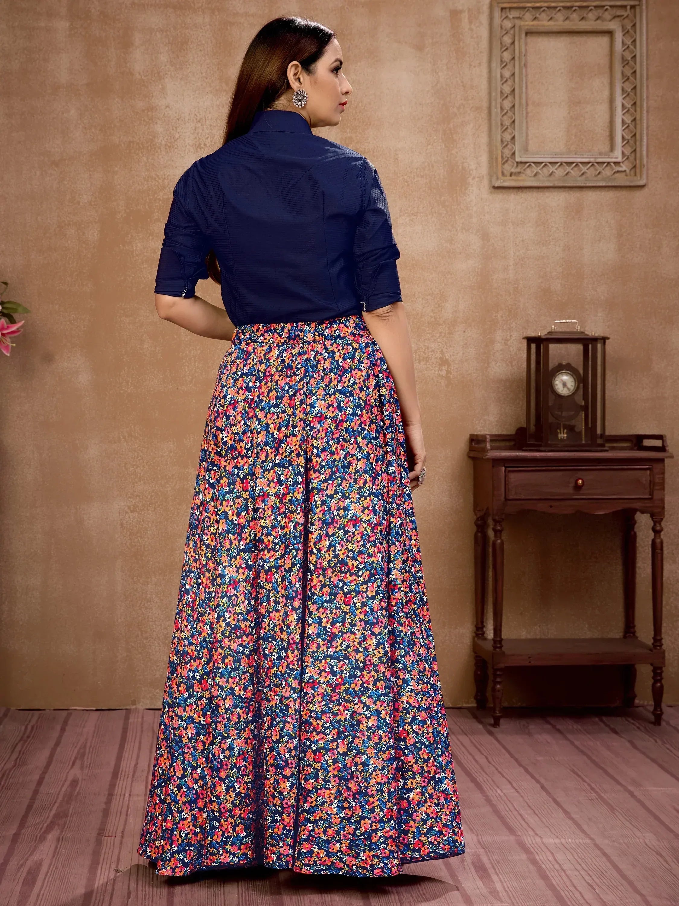 Woman in navy blue top and floral print ethnic skirt, stylish Indian wear for festive occasions