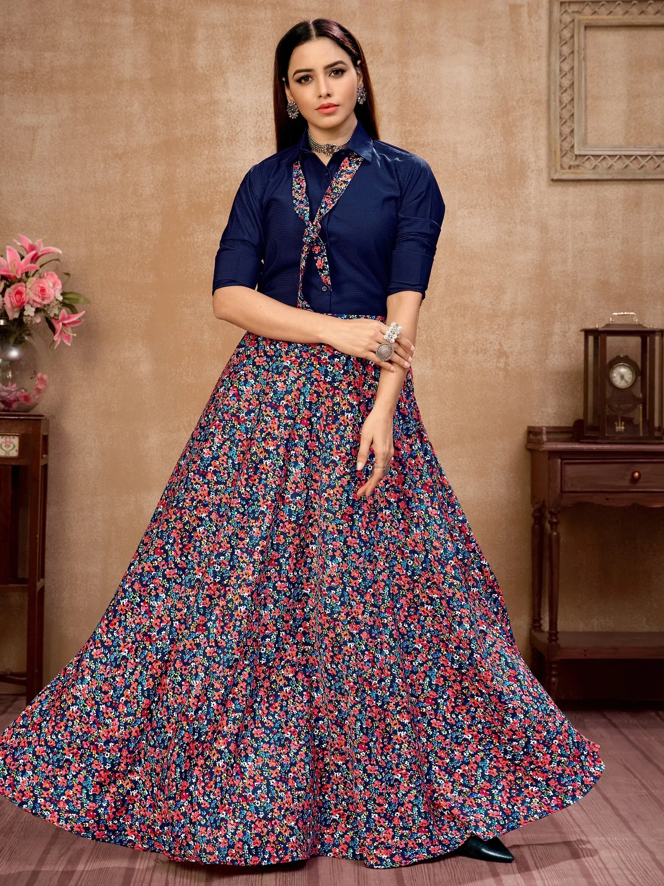 Woman in navy blue floral print ethnic gown with tie-neck top, perfect for Indian occasions