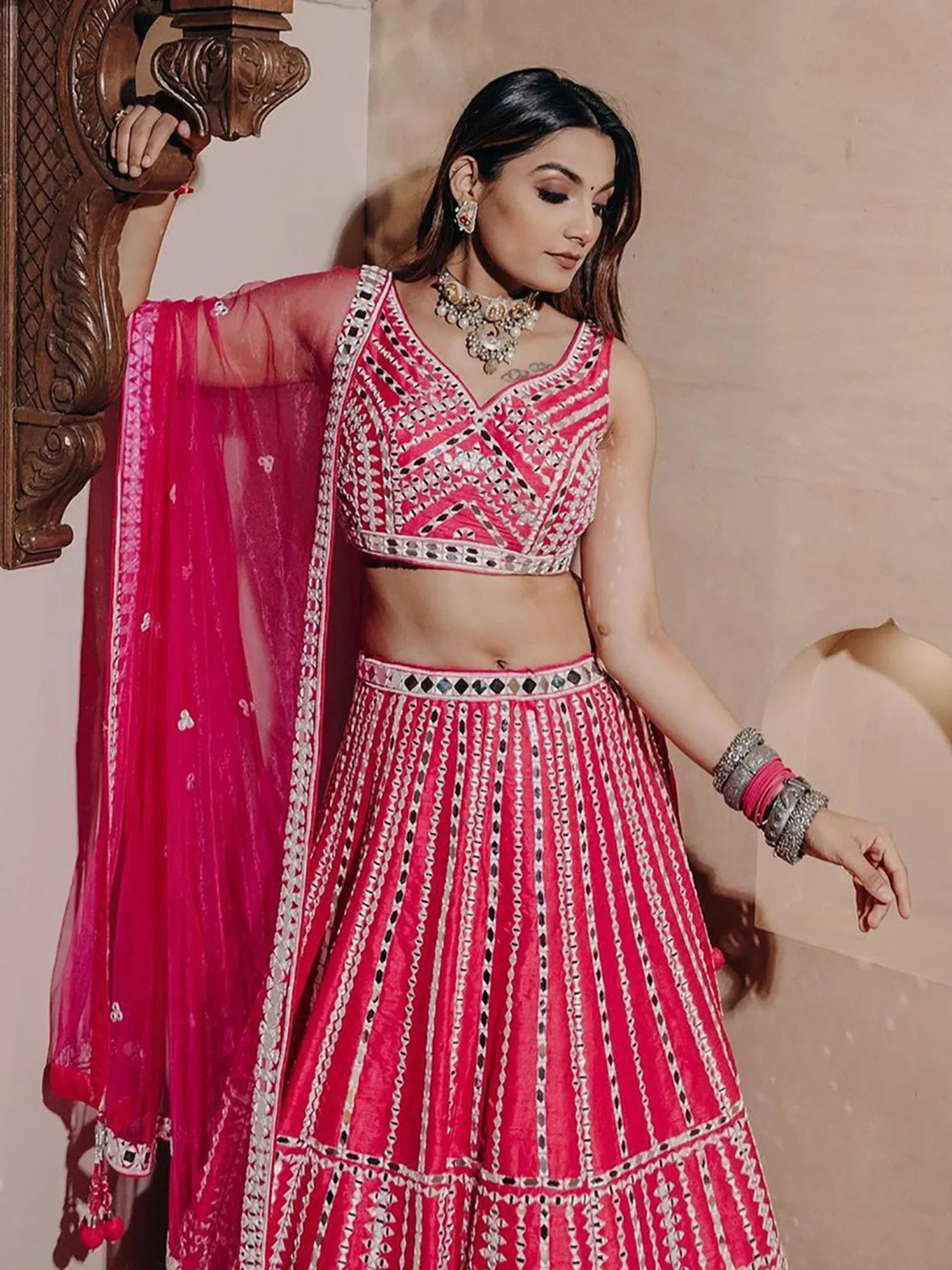Pink embroidered lehenga choli with mirror work and sheer dupatta, perfect for Indian ethnic wear occasions