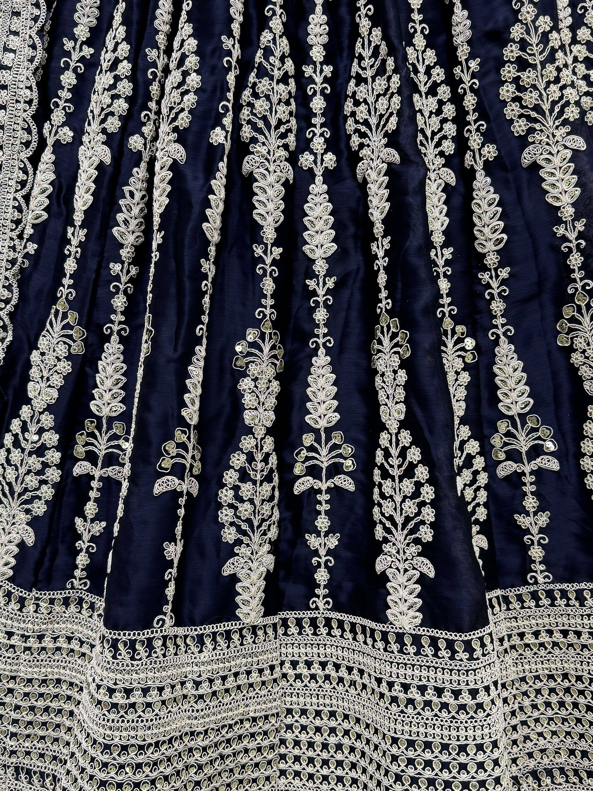 Navy blue ethnic wear with intricate white floral embroidery and sequin detailing, perfect for Indian occasions.