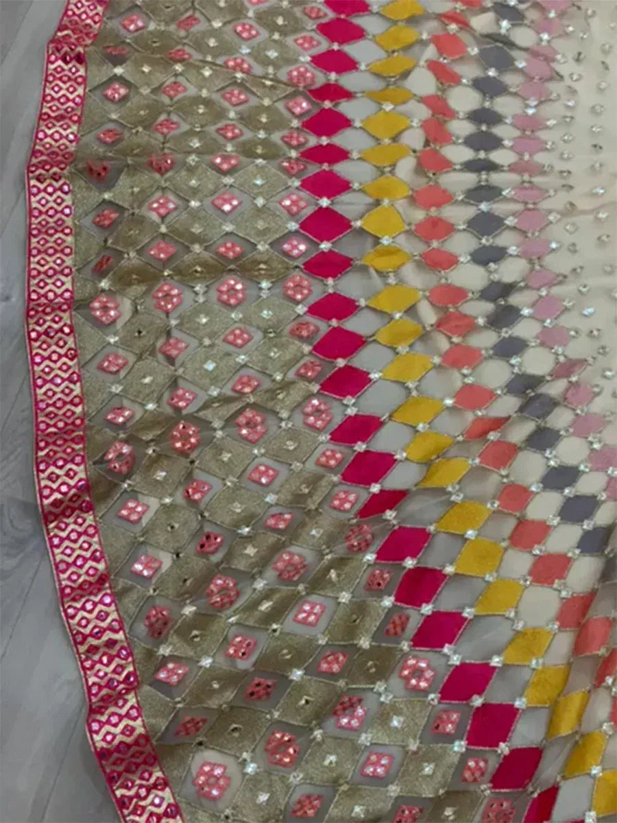 Colorful ethnic lehenga choli fabric with mirror work and geometric patterns, perfect for Indian festive wear