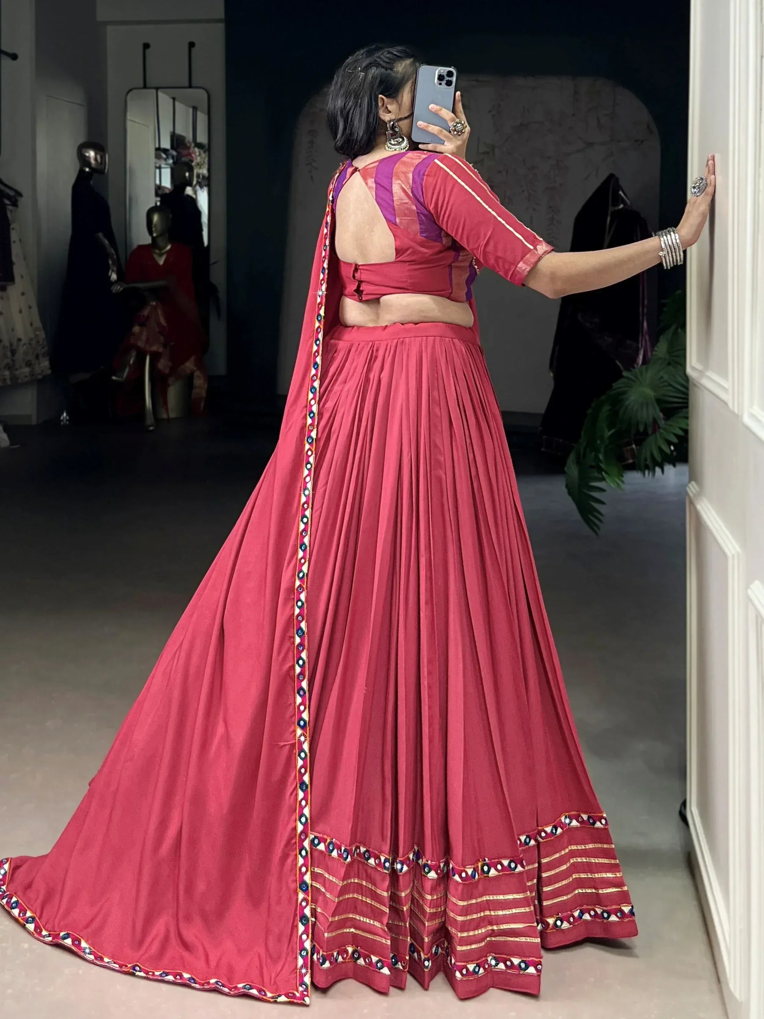 Pink lehenga choli with mirror work, backless blouse, and pleated skirt for Indian ethnic wear