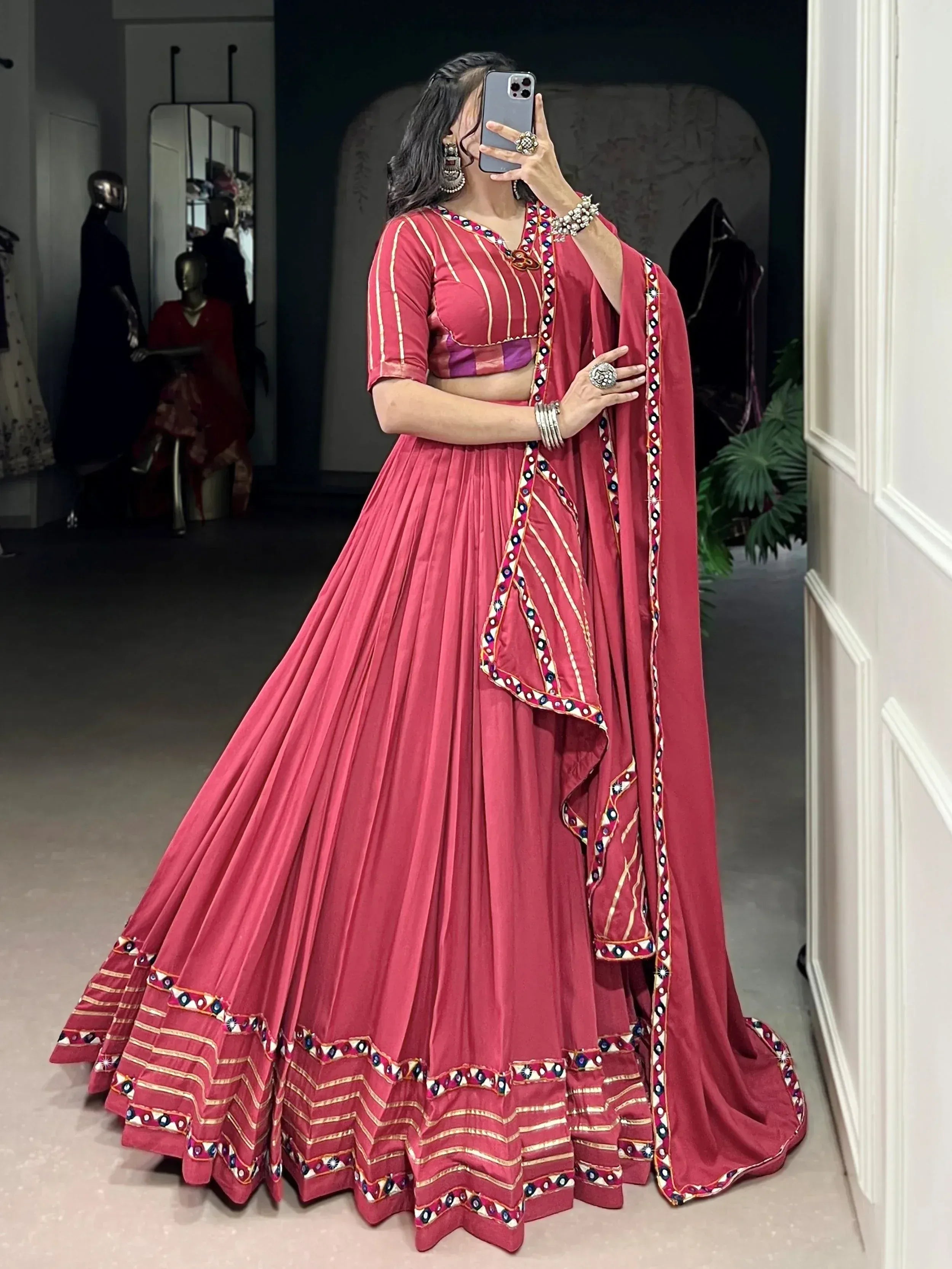 Pink embroidered lehenga choli with mirror work, perfect for Indian ethnic wear and festive occasions.