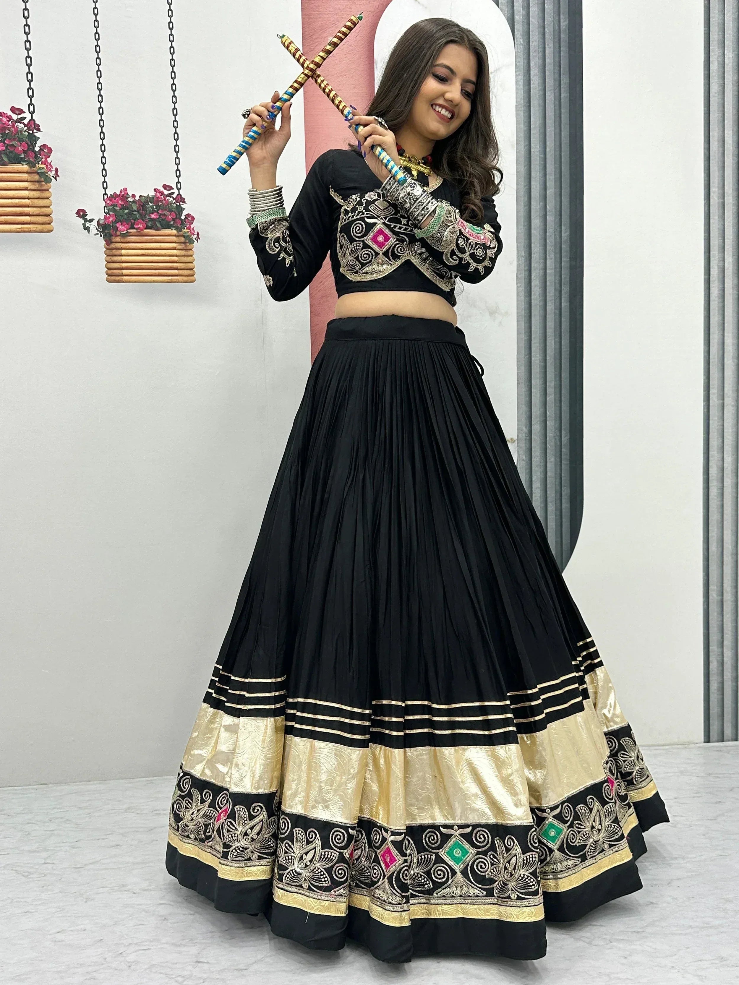 Black embroidered lehenga choli with gold border, perfect for Indian ethnic wear and festive occasions.