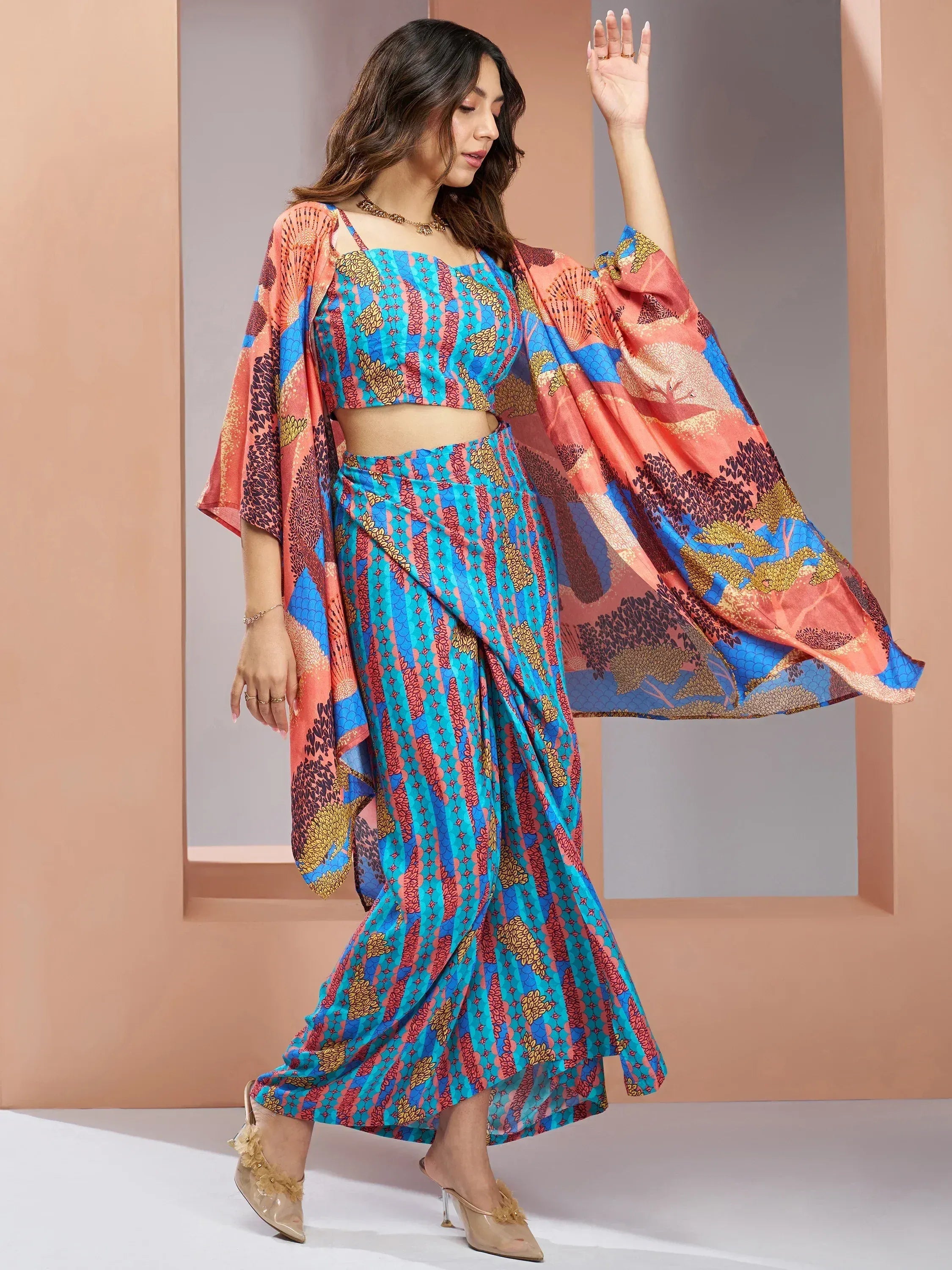Woman in vibrant printed ethnic lehenga choli with cape, perfect for Indian occasions and festivals.