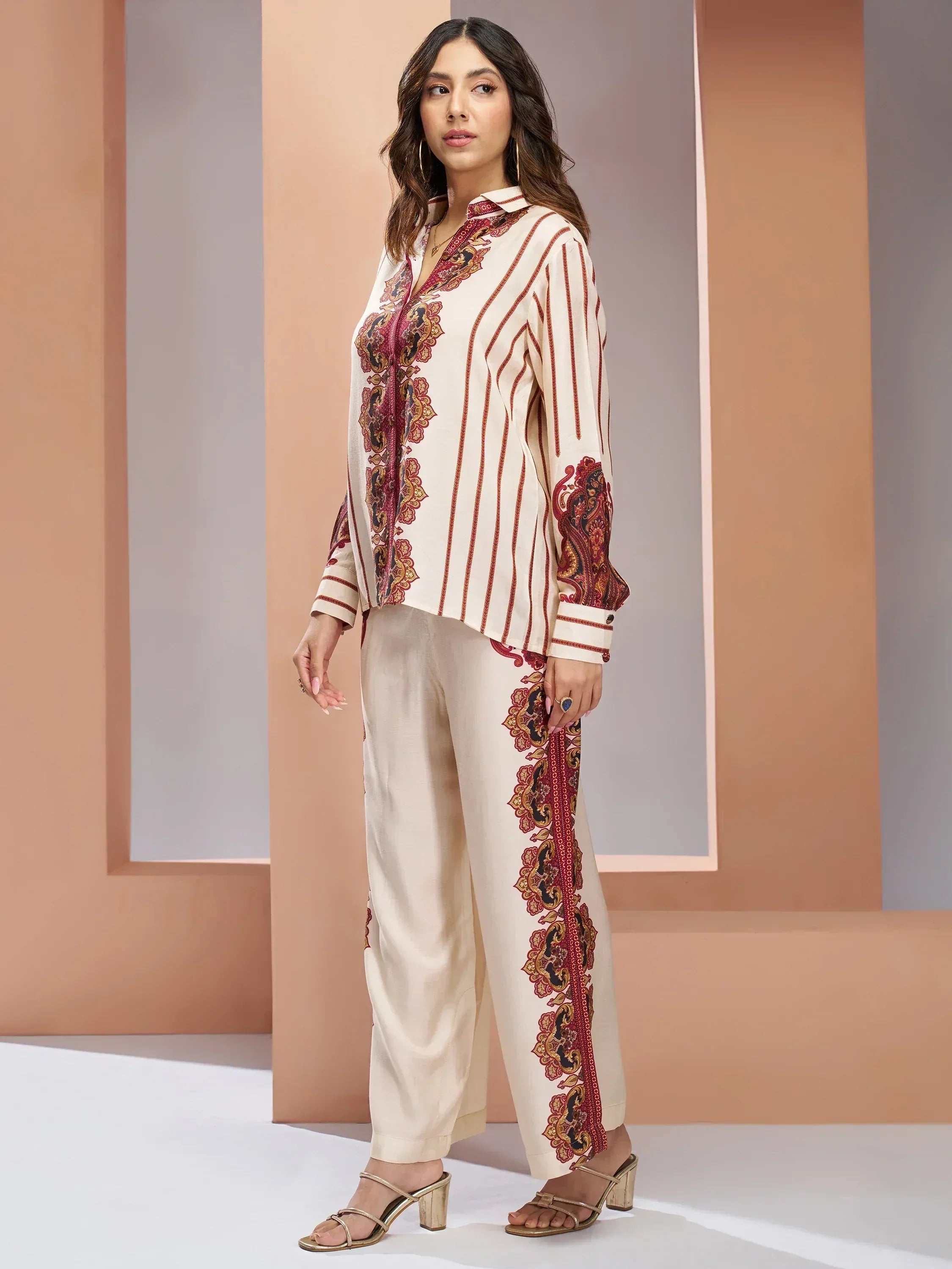 Cream ethnic palazzo set with red paisley print, perfect for Indian occasions and festive wear.
