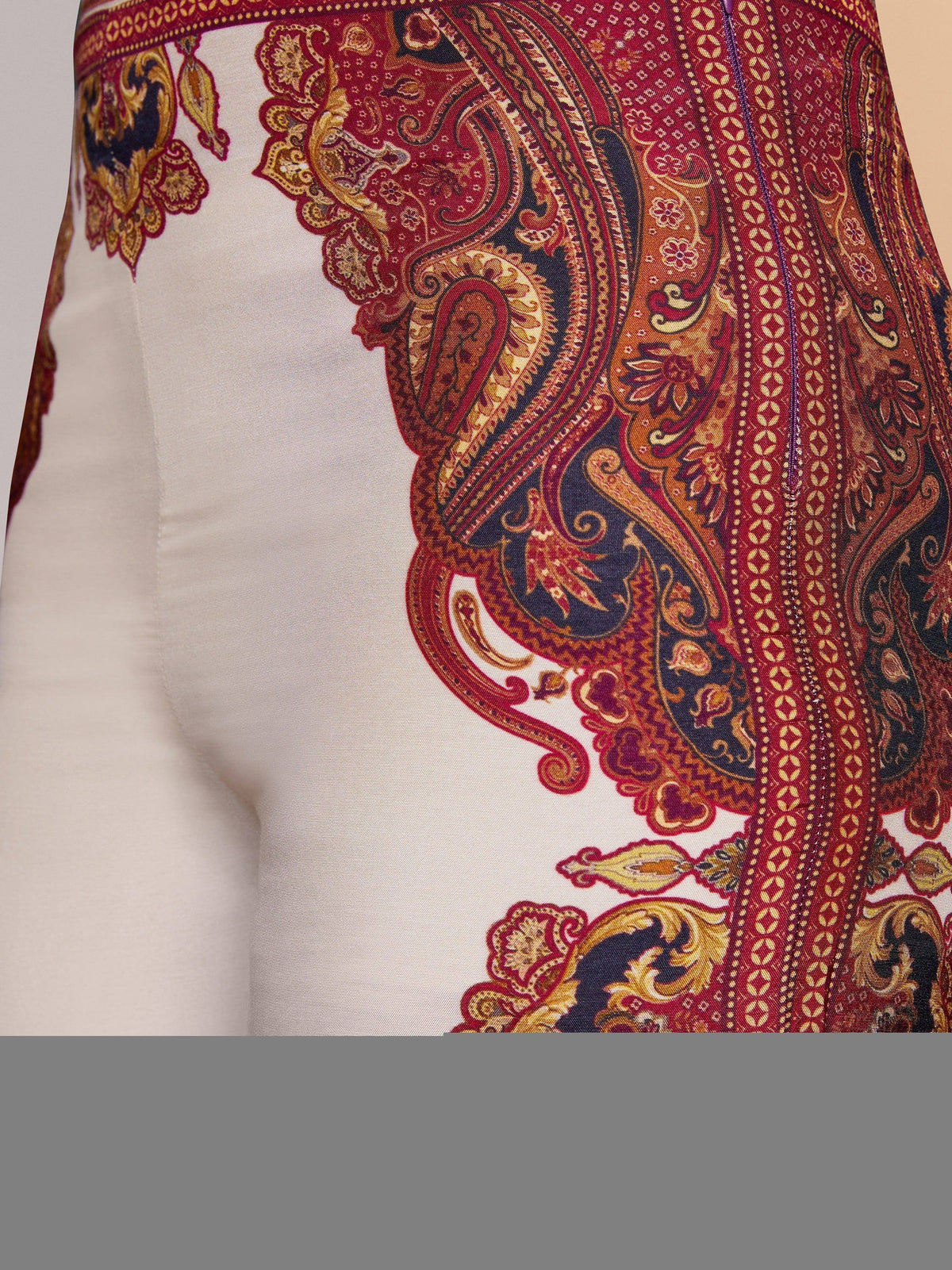 White ethnic gown with red and gold paisley print, perfect for Indian festive occasions