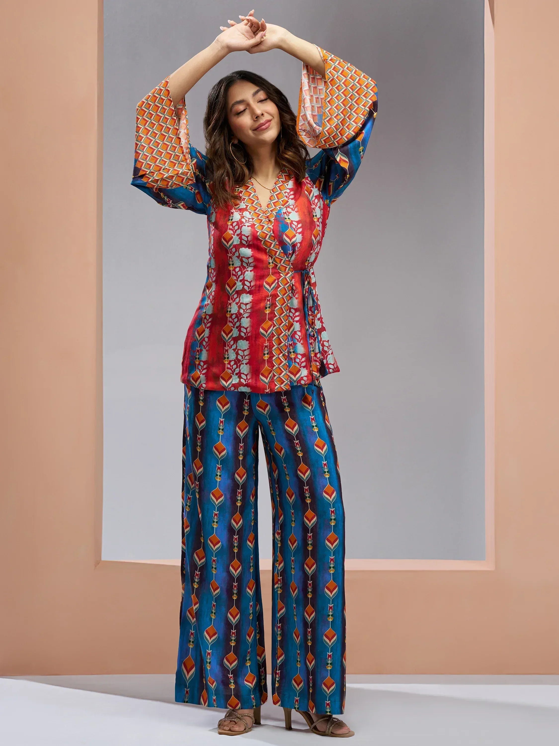 Woman in vibrant printed ethnic palazzo set with bell sleeves, perfect for Indian festive wear