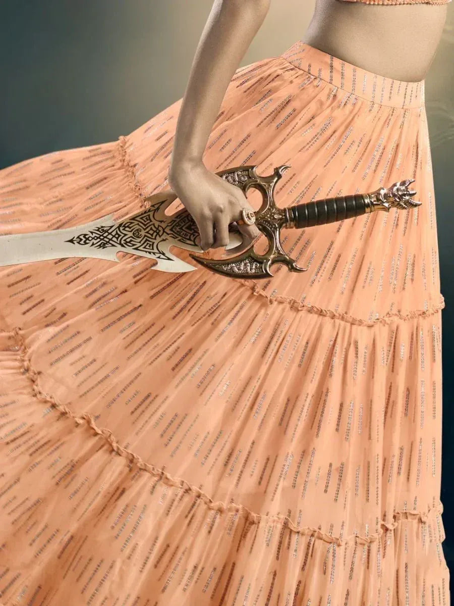 Woman in peach lehenga holding ornate sword, ethnic wear fashion