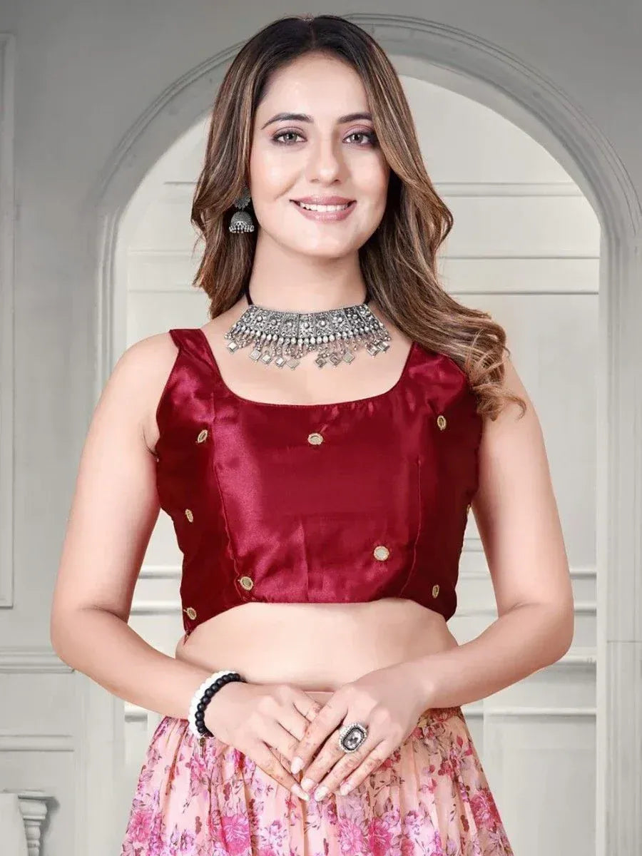 Maroon satin blouse with gold buttons paired with floral lehenga, styled with ethnic jewelry for Indian wear