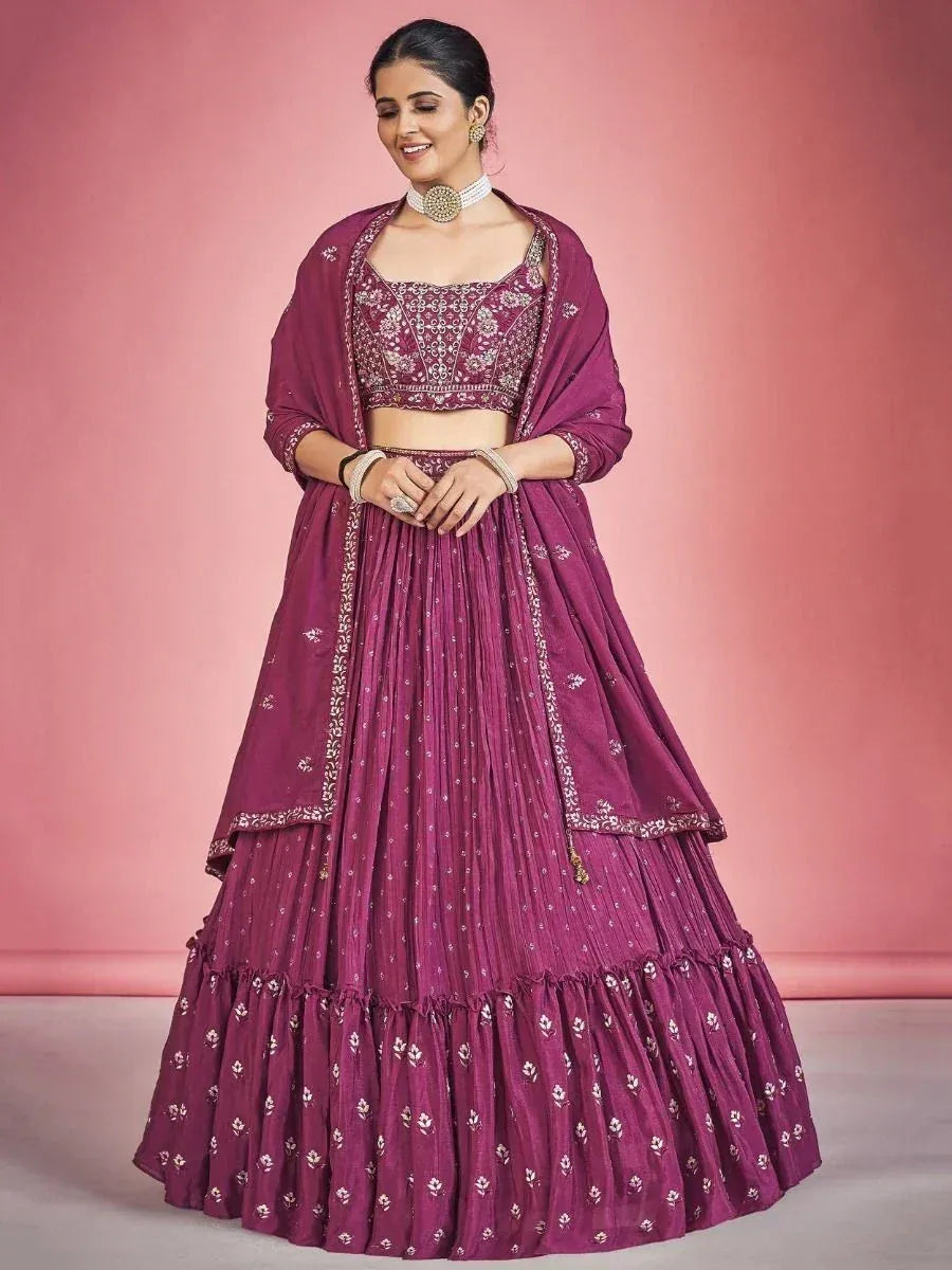Elegant maroon lehenga choli with intricate embroidery, perfect for Indian weddings and festive occasions.