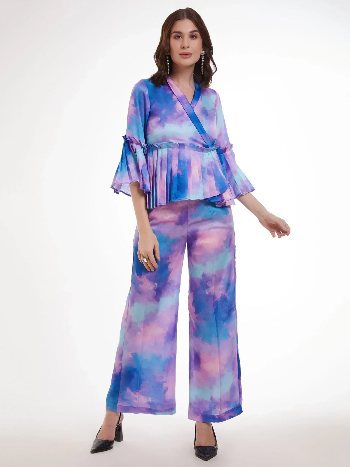 Woman in vibrant tie-dye ethnic palazzo set with ruffled top, perfect for Indian festive occasions.