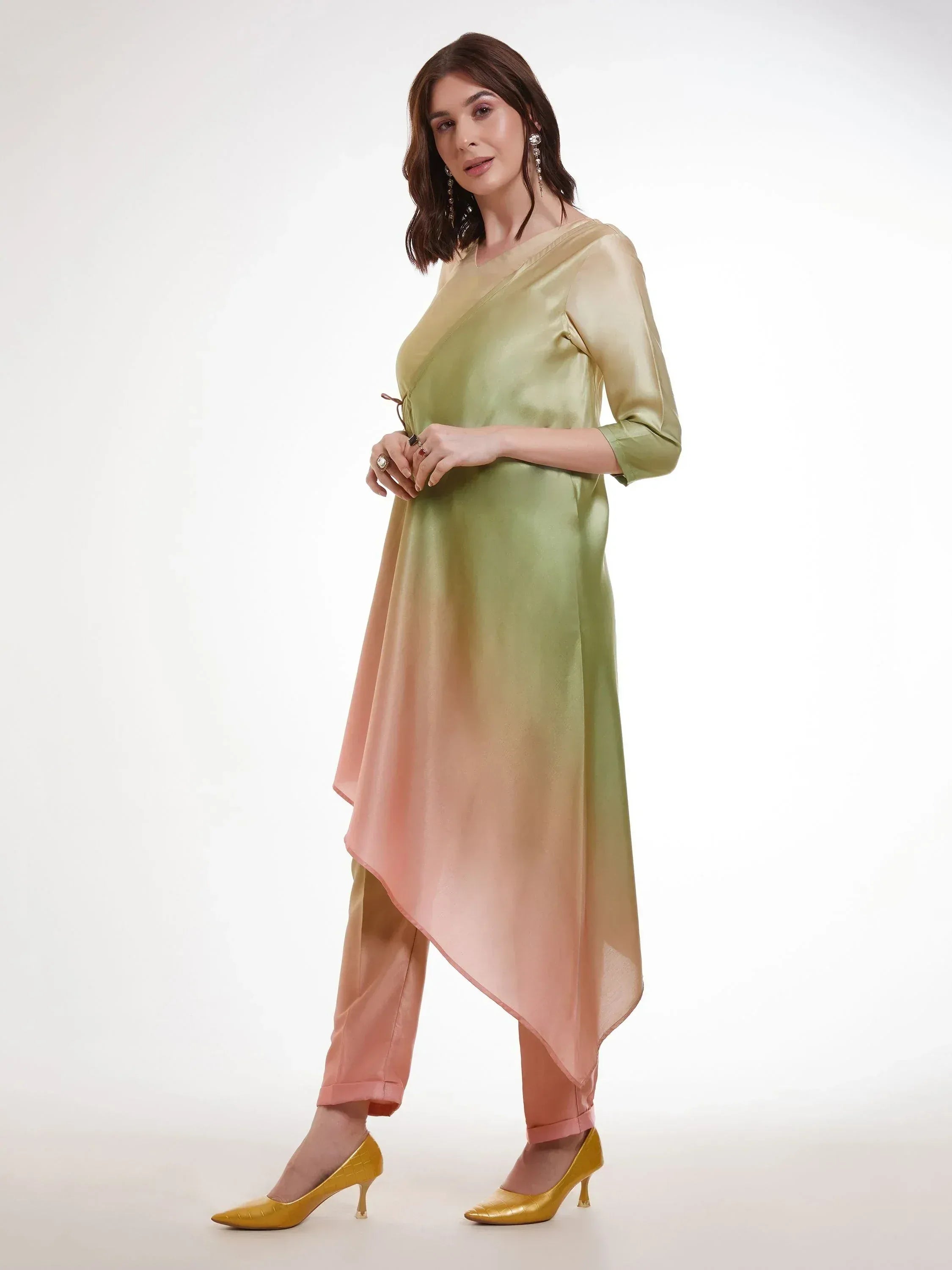 Woman wearing an ombre green and peach asymmetrical kurti with matching pants