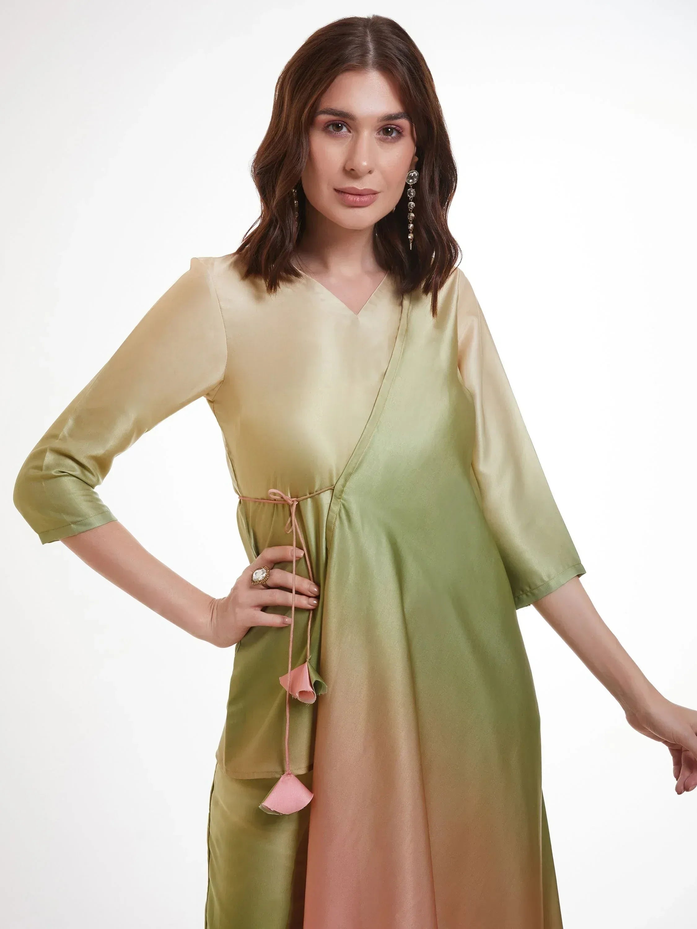 Woman wearing a pastel green and peach silk kurti with three-quarter sleeves and tassel tie