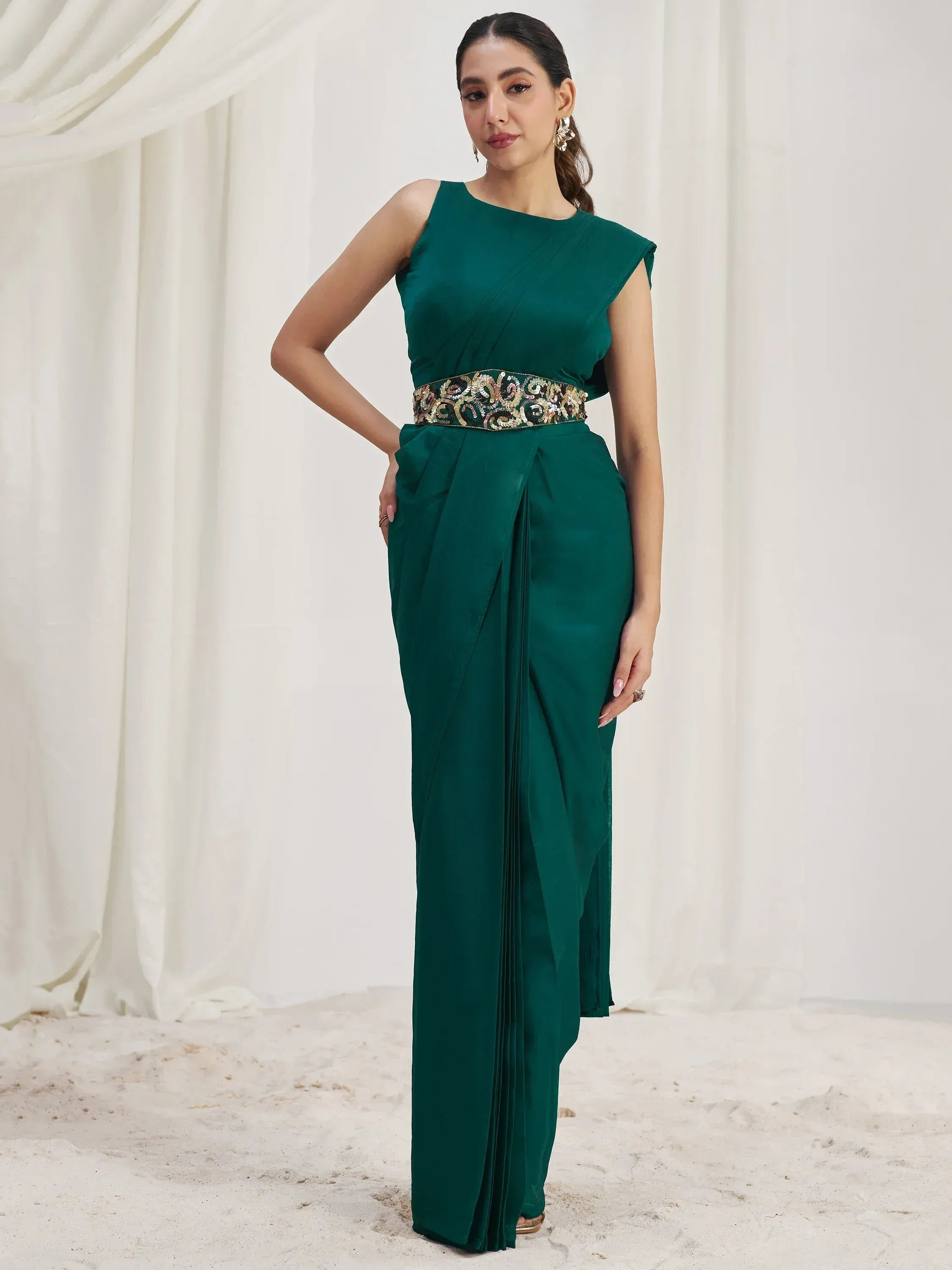 Emerald green ethnic gown with embroidered waistband, perfect for Indian festive occasions