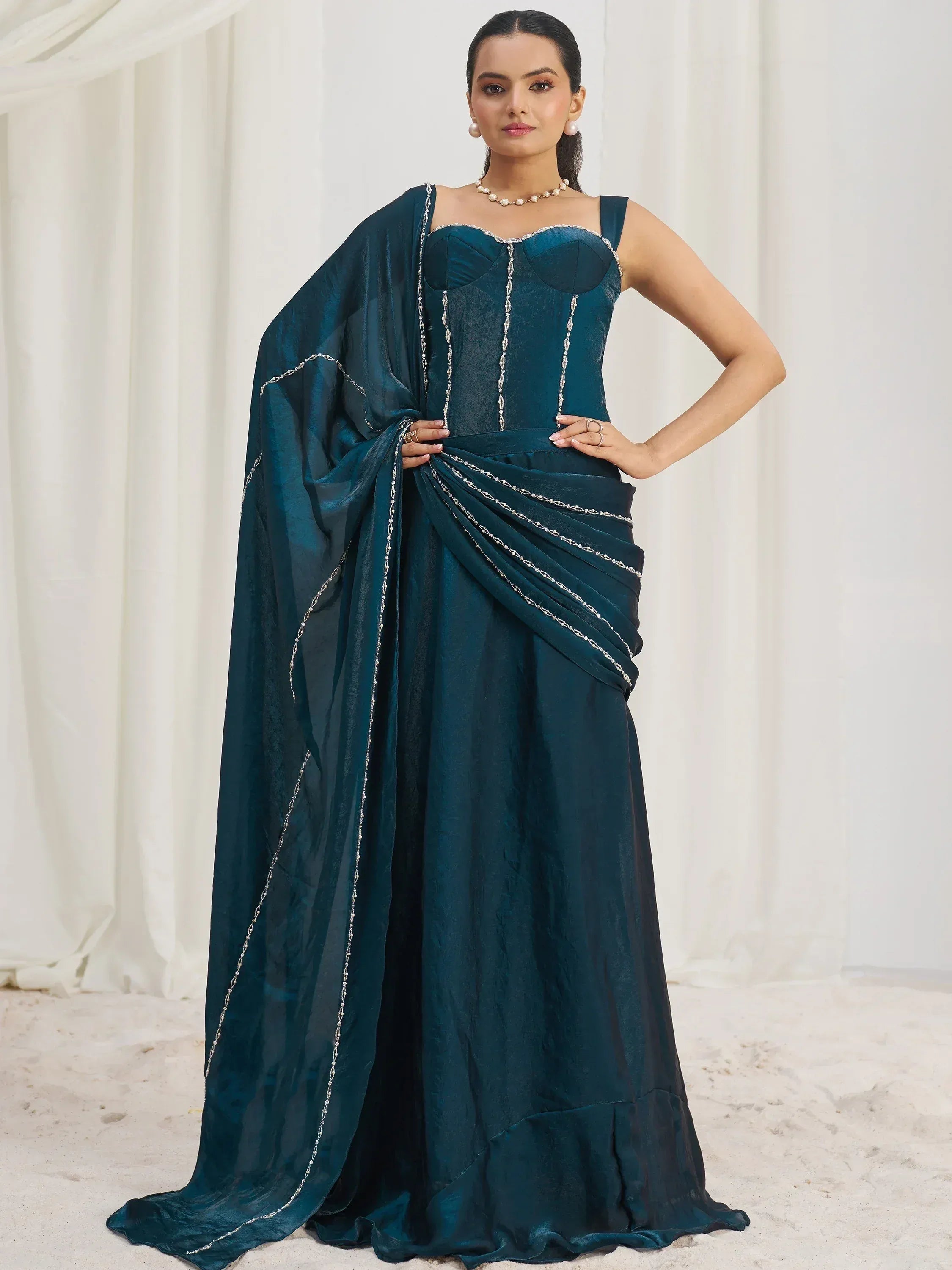Elegant teal ethnic gown with silver chain detailing, perfect for Indian festive occasions.