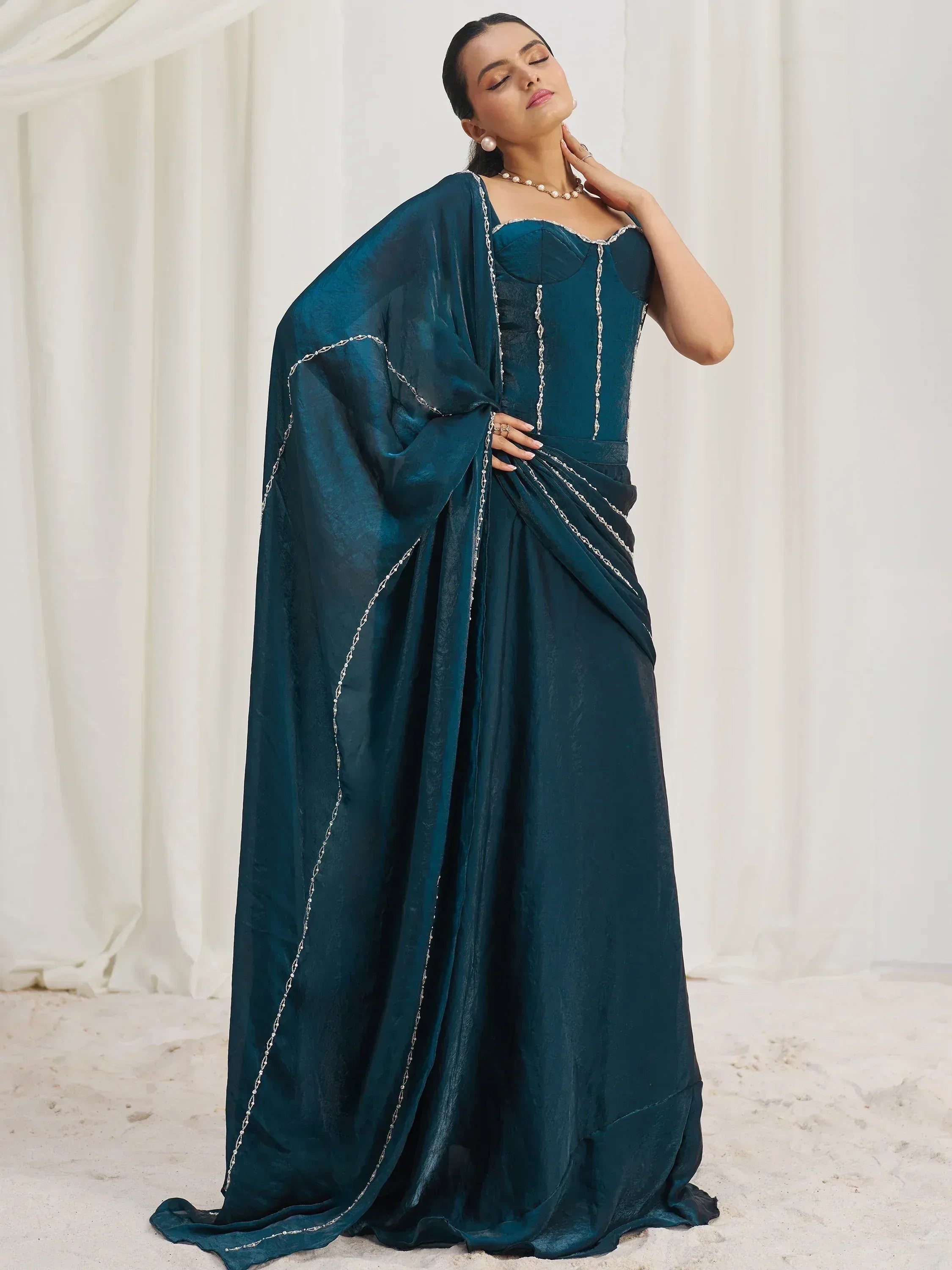 Elegant teal ethnic gown with silver chain detailing, perfect for Indian festive occasions.