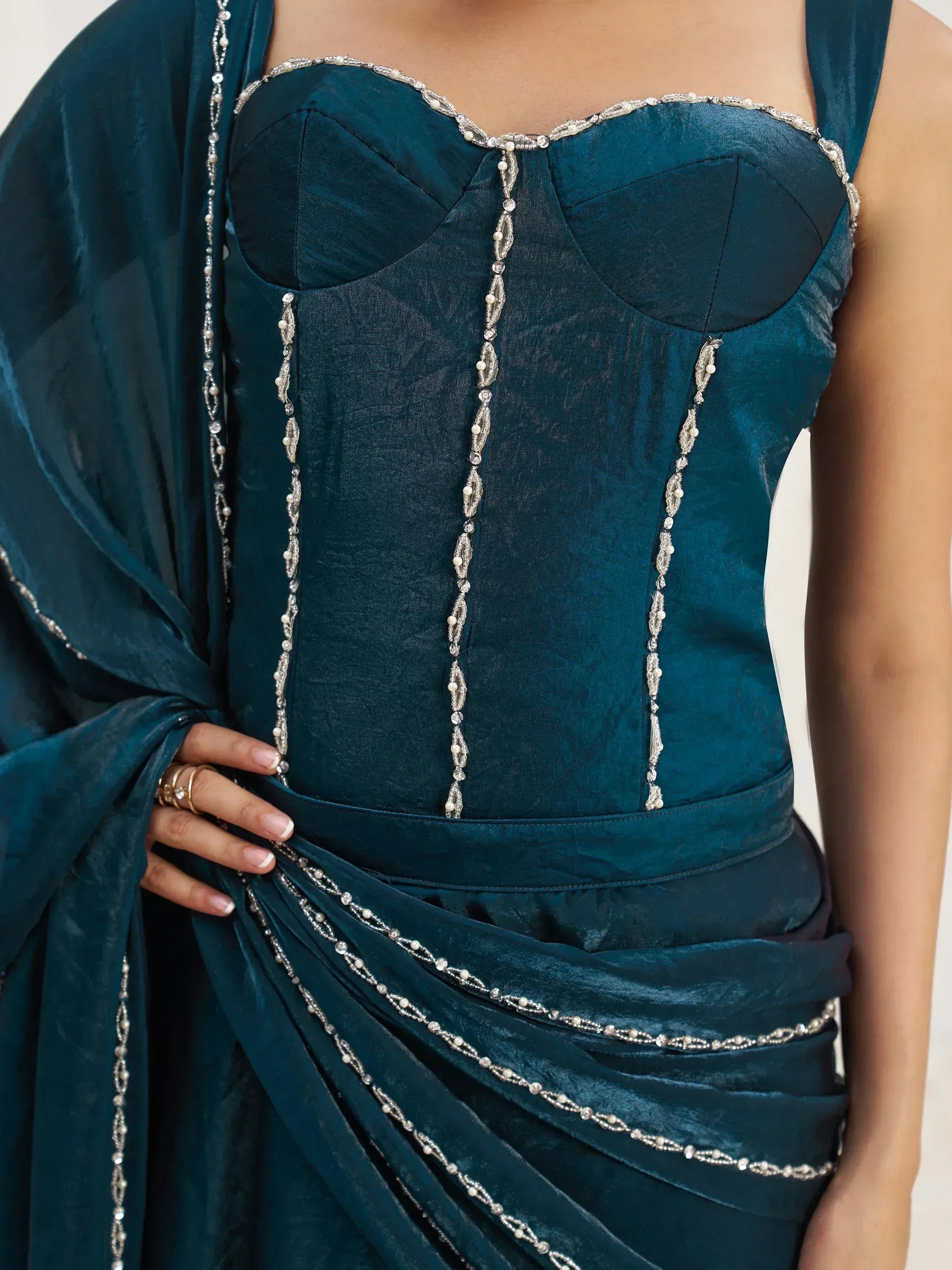 Teal velvet ethnic gown with intricate silver beadwork and draped detailing