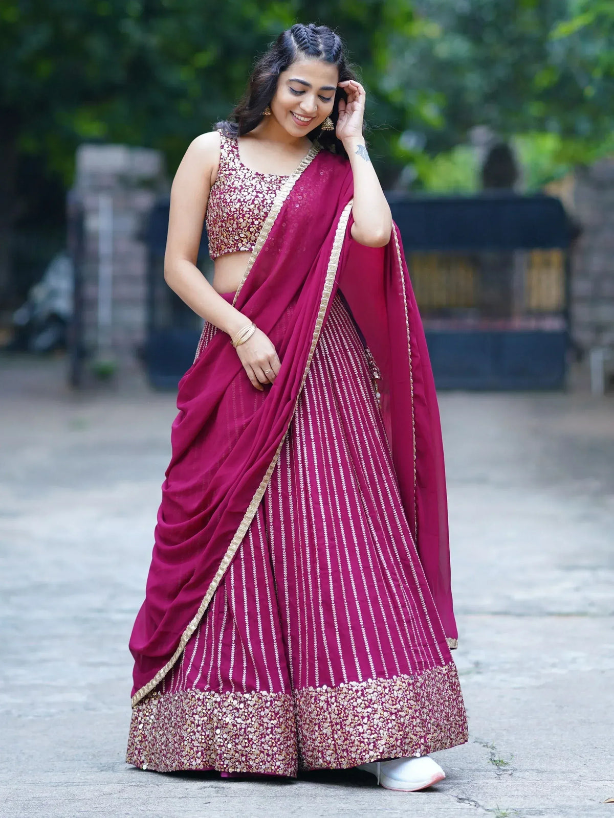 Woman in maroon lehenga choli with gold embroidery, perfect for Indian ethnic wear occasions