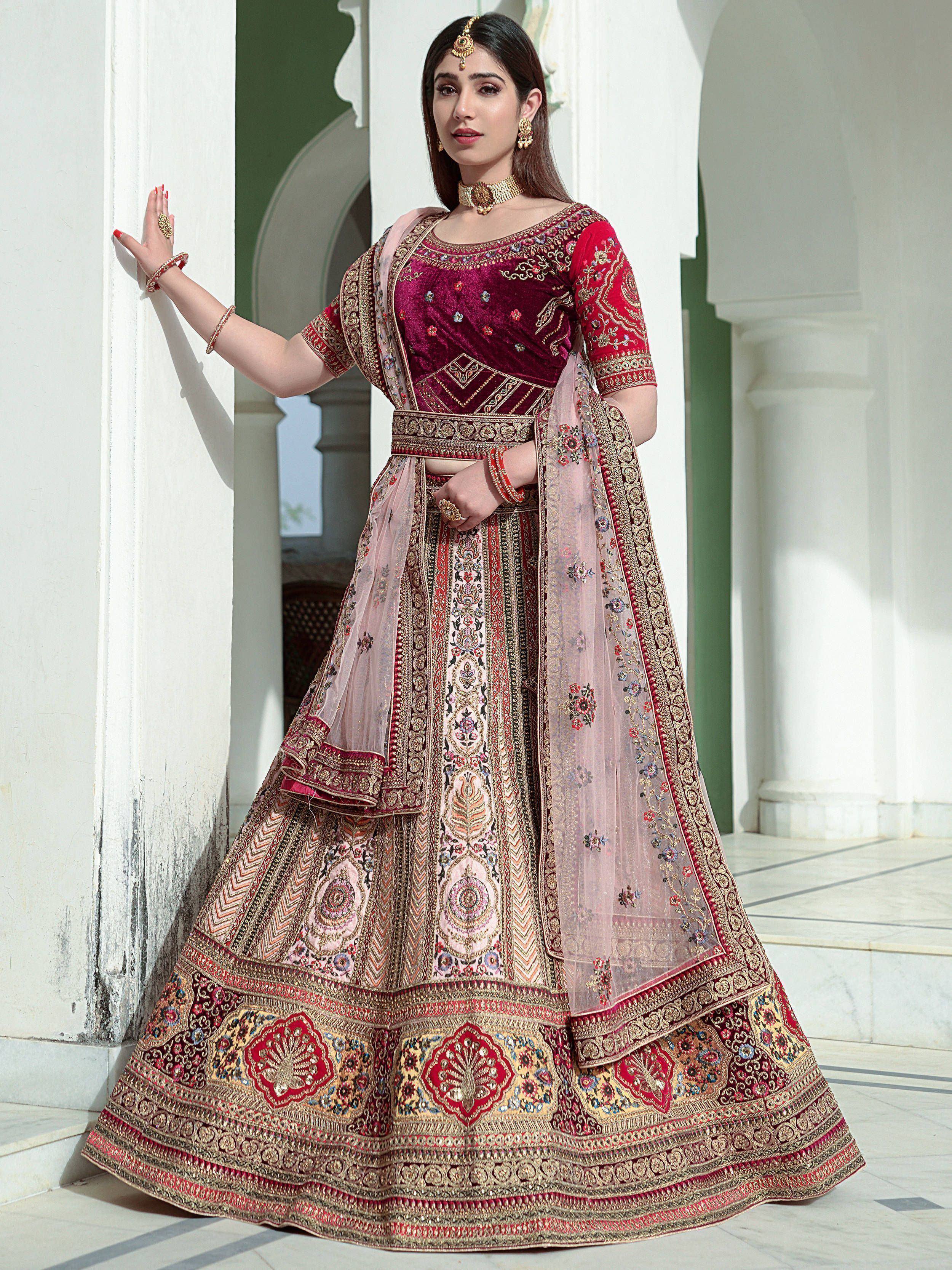 Elegant maroon velvet lehenga choli with heavy embroidery, perfect for Indian weddings and festive occasions.