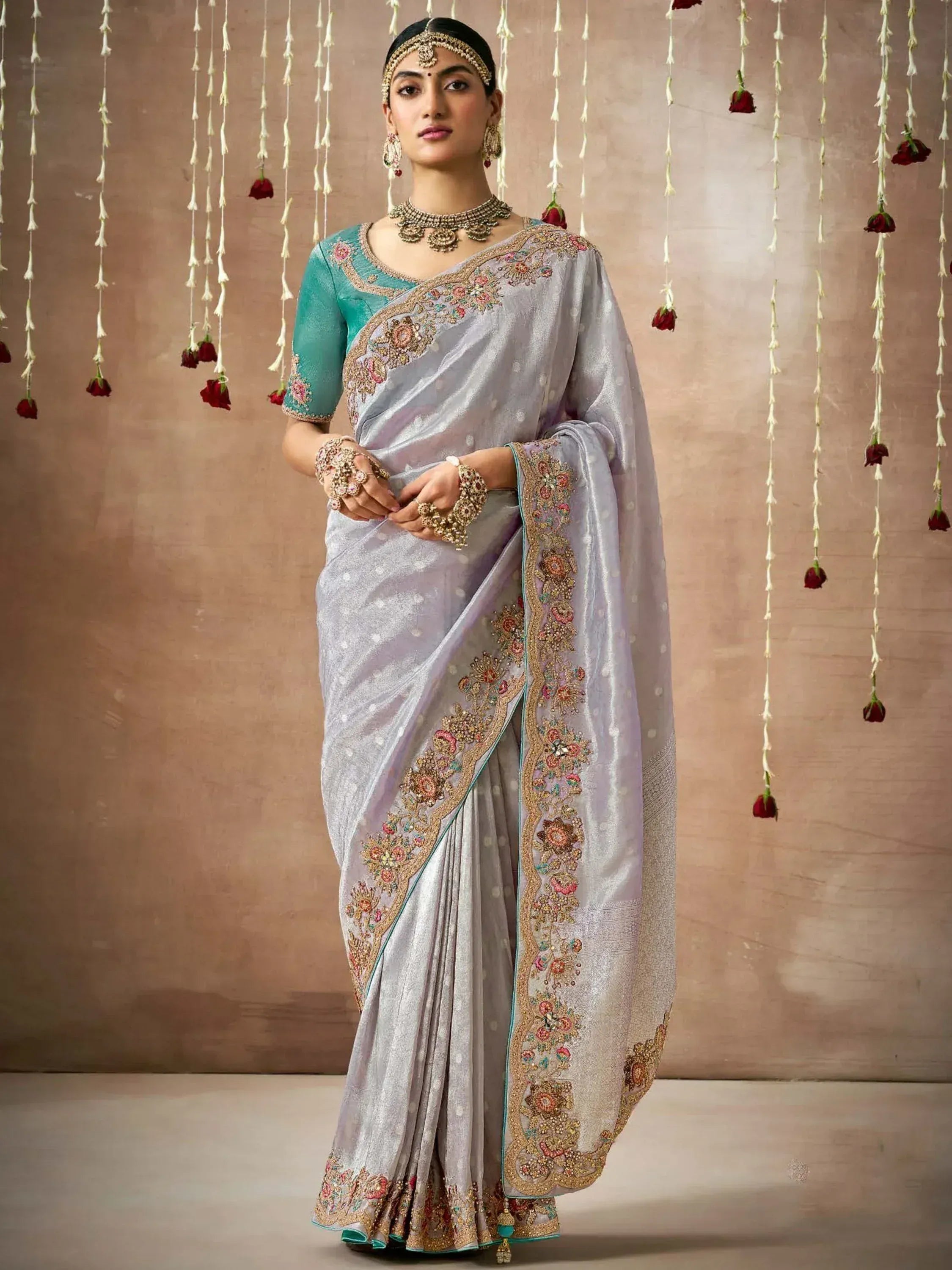 Elegant lavender saree with floral embroidery and teal blouse, perfect for Indian ethnic occasions