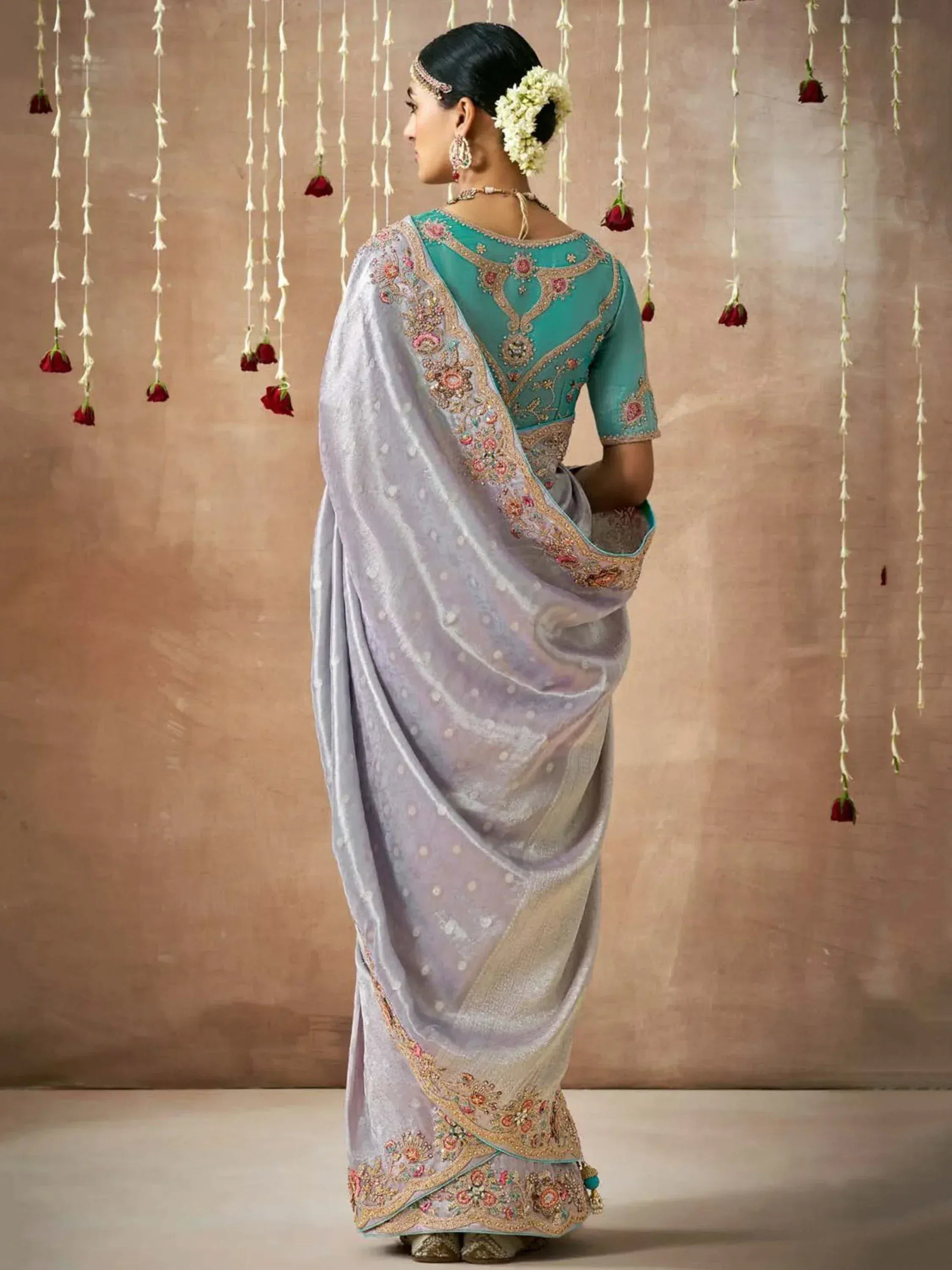 Elegant lavender saree with teal blouse, floral embroidery, and gold detailing for Indian ethnic wear