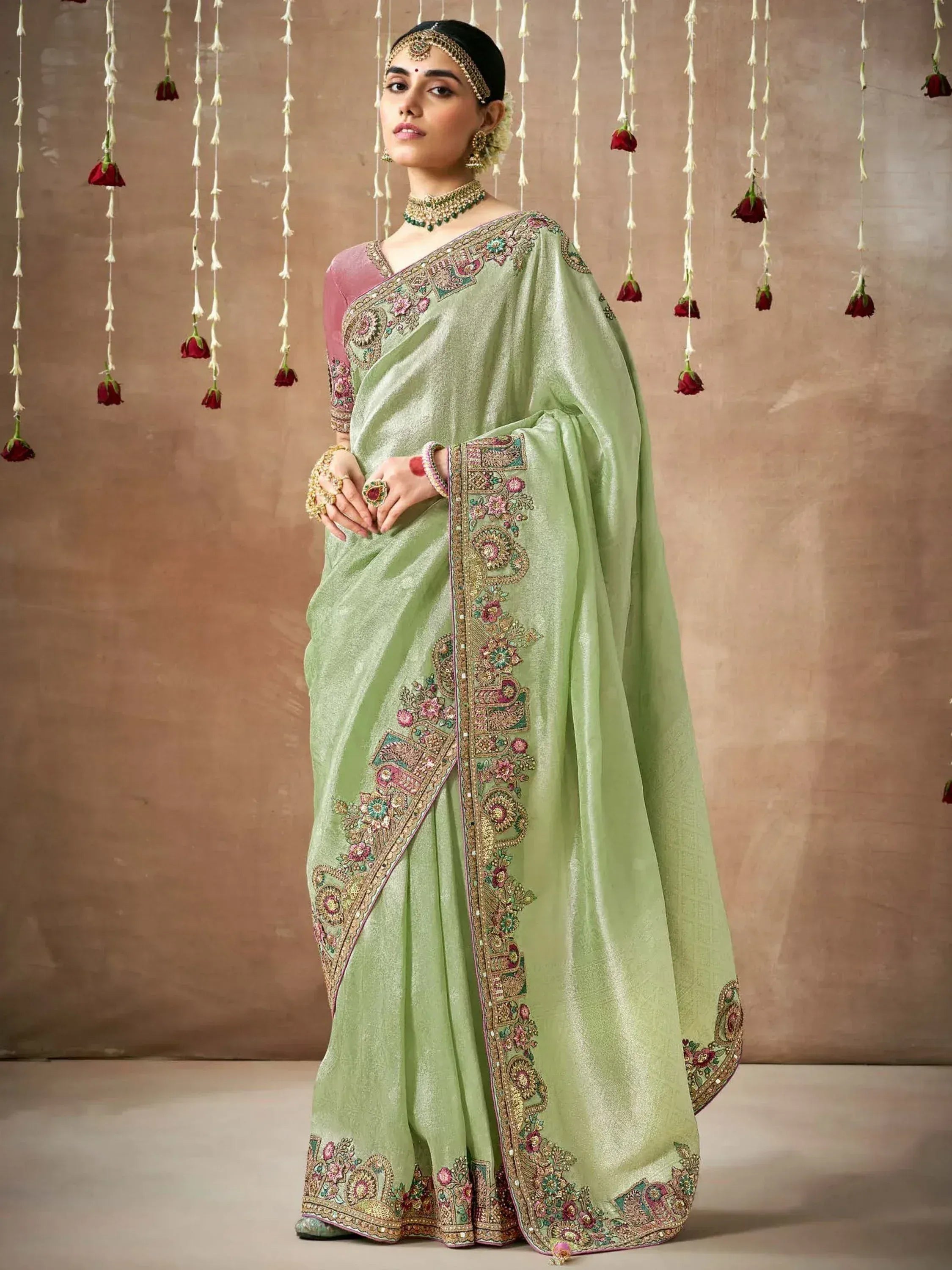 Elegant light green embroidered saree with pink blouse, perfect for Indian ethnic occasions and weddings.