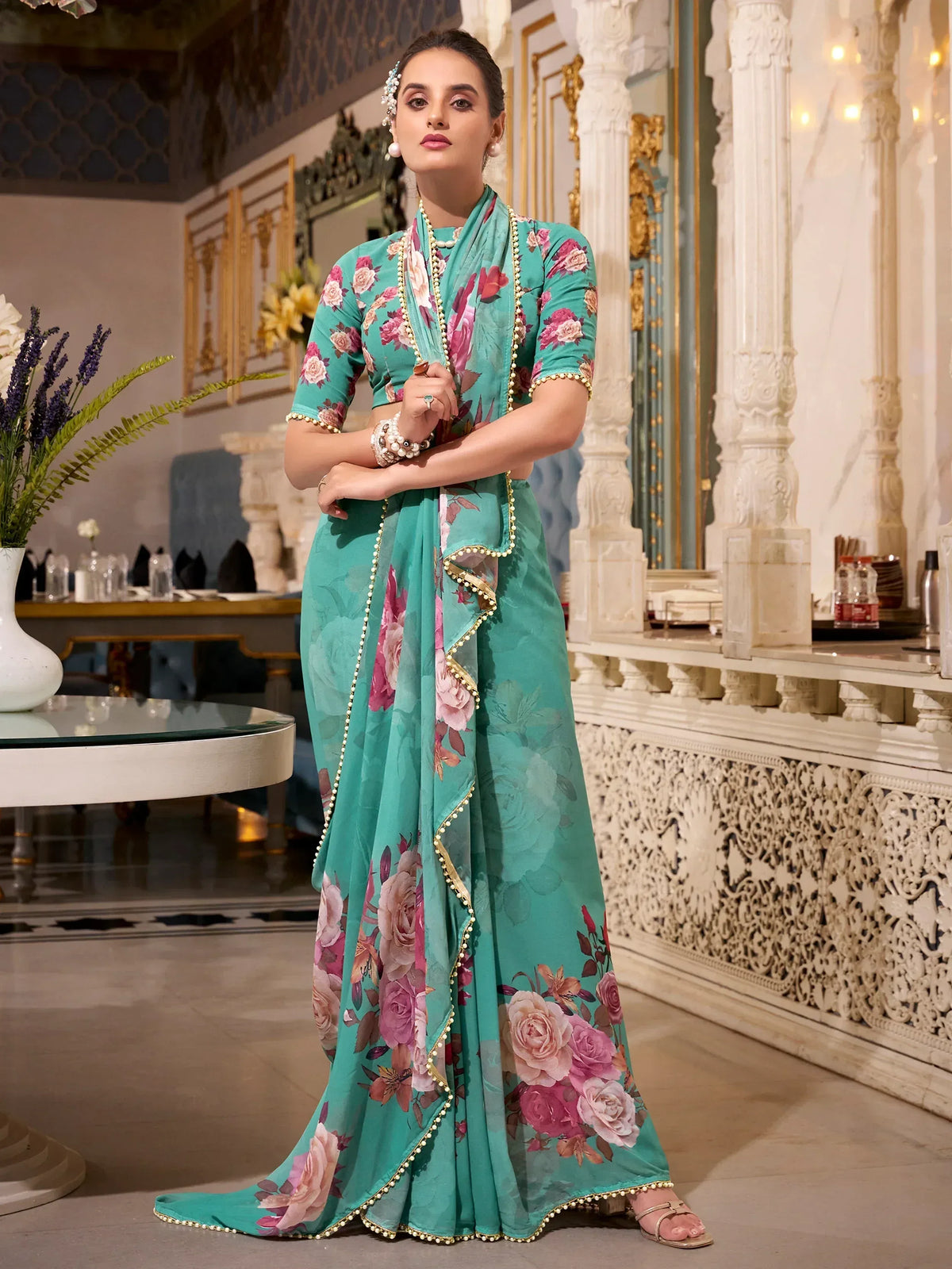 Teal floral print ethnic gown with gold trim, perfect for Indian occasions and festive wear