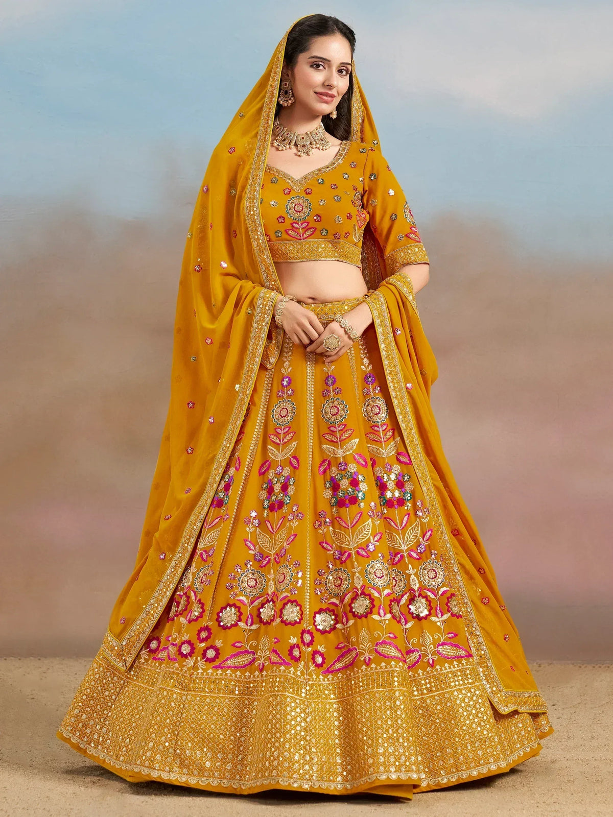 Mustard yellow embroidered lehenga choli with floral motifs and dupatta, perfect for Indian weddings and festive occasions.