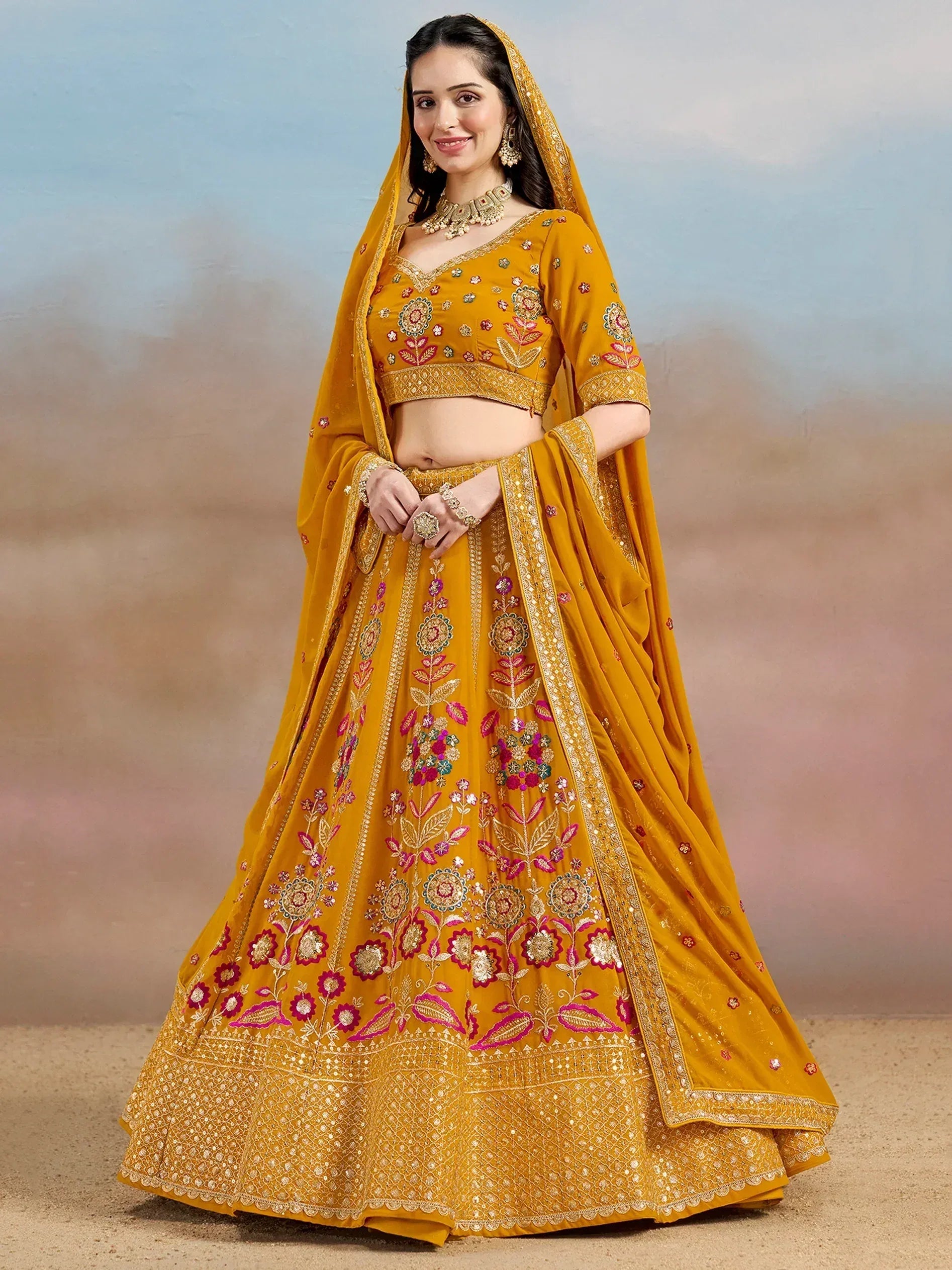 Mustard yellow embroidered lehenga choli with floral motifs and dupatta, perfect for Indian weddings and festive occasions.