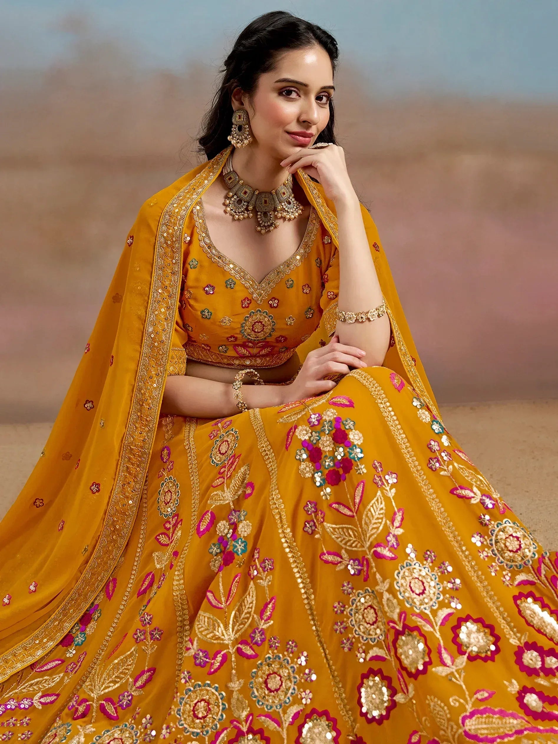 Yellow embroidered lehenga choli with floral motifs and gold detailing, perfect for Indian ethnic occasions.