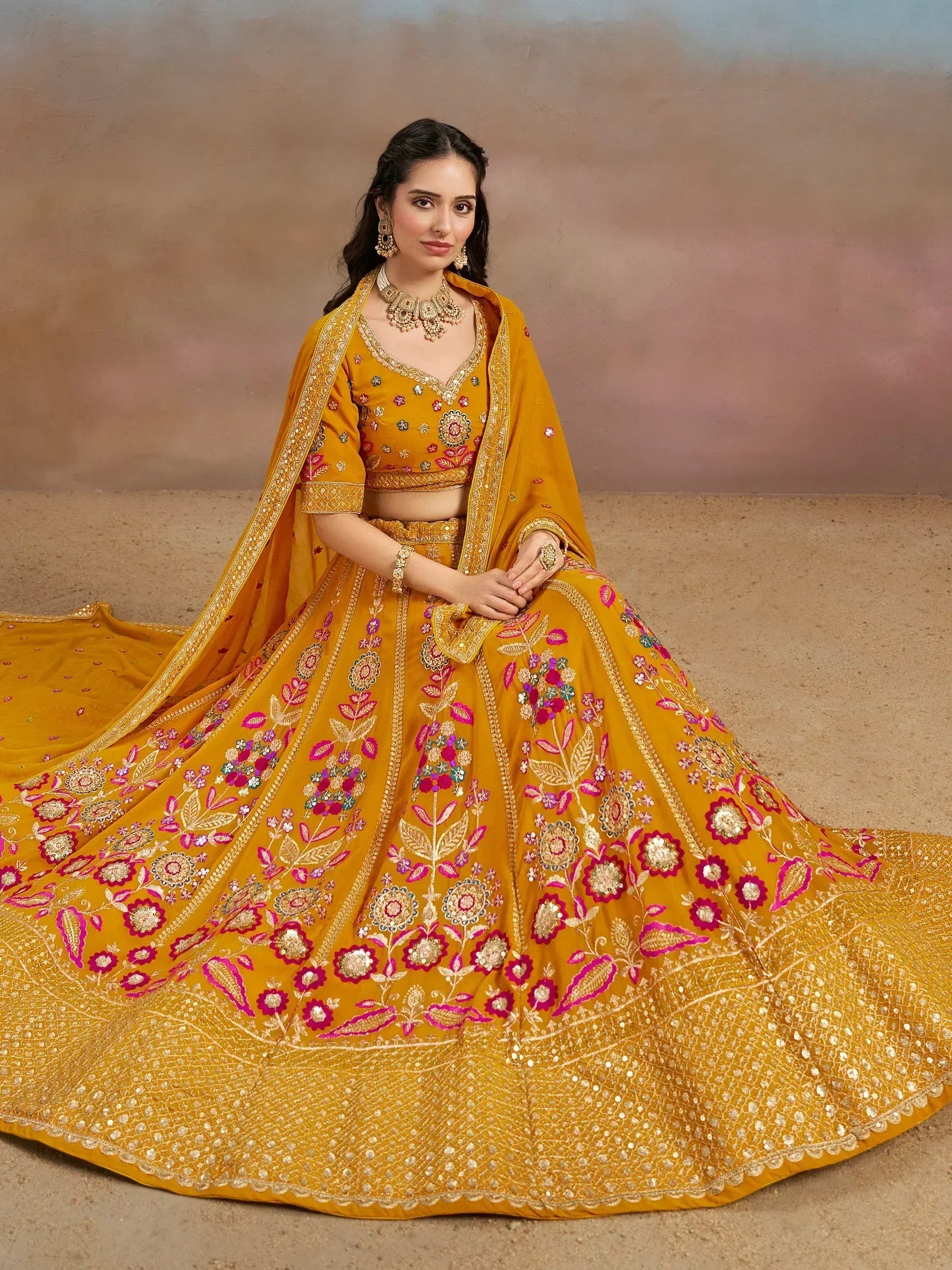 Mustard yellow designer lehenga choli with floral embroidery and gold detailing, perfect for weddings and festive occasions.