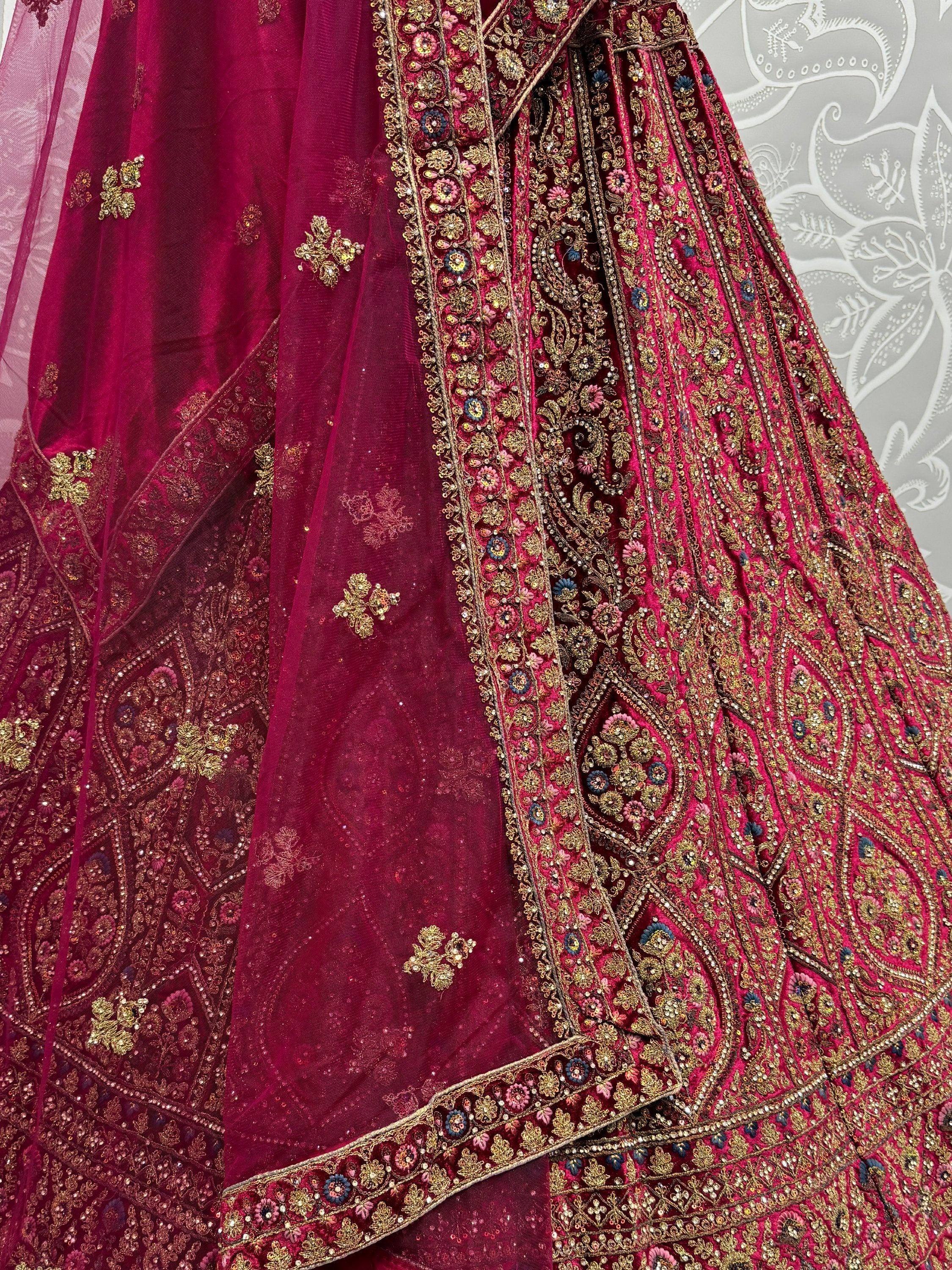 Elegant maroon lehenga choli with intricate gold embroidery and floral embellishments