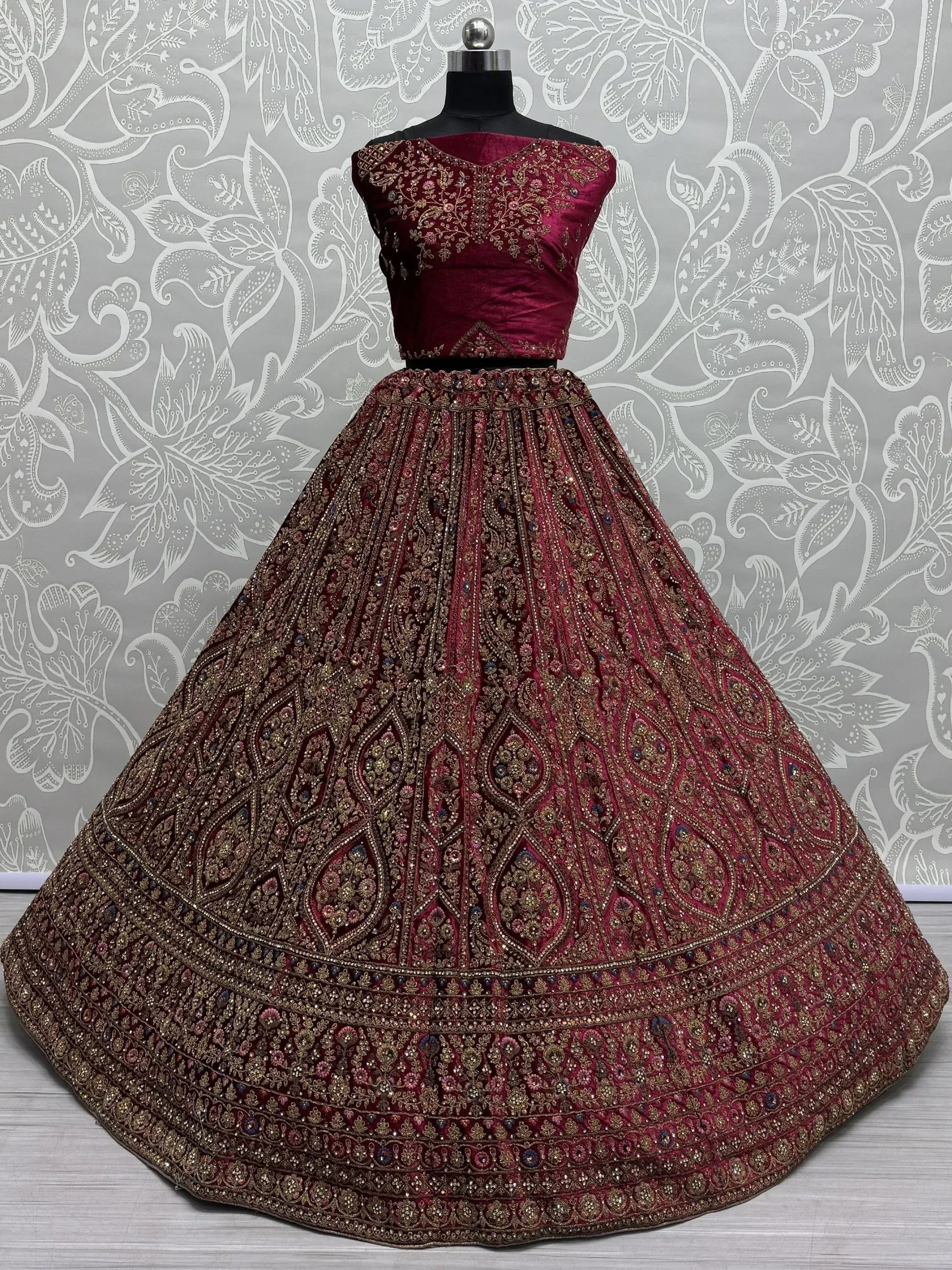 Maroon designer lehenga choli with intricate gold embroidery and embellishments