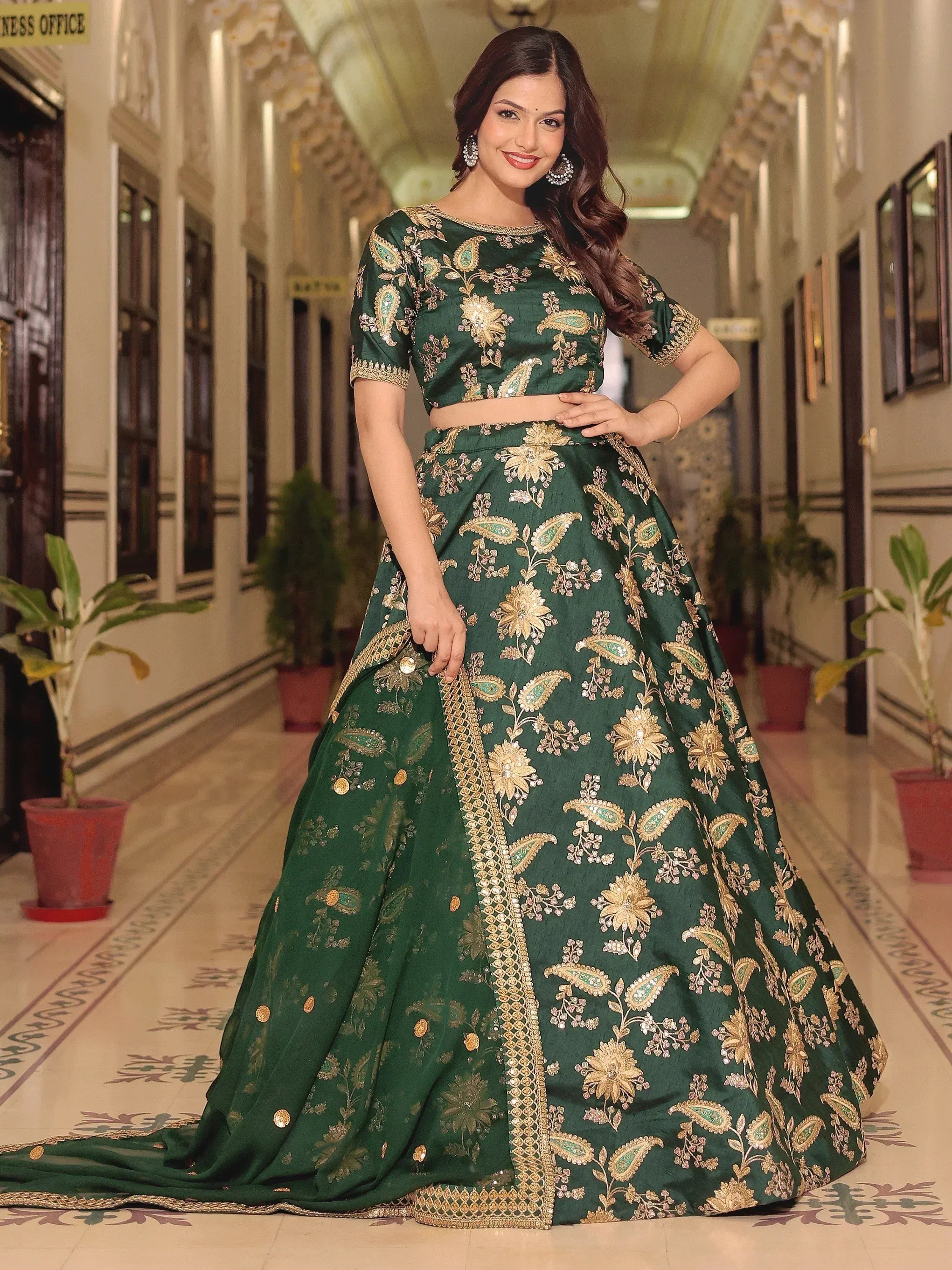 Emerald green designer lehenga choli with gold floral embroidery, perfect for Indian weddings and festive occasions.