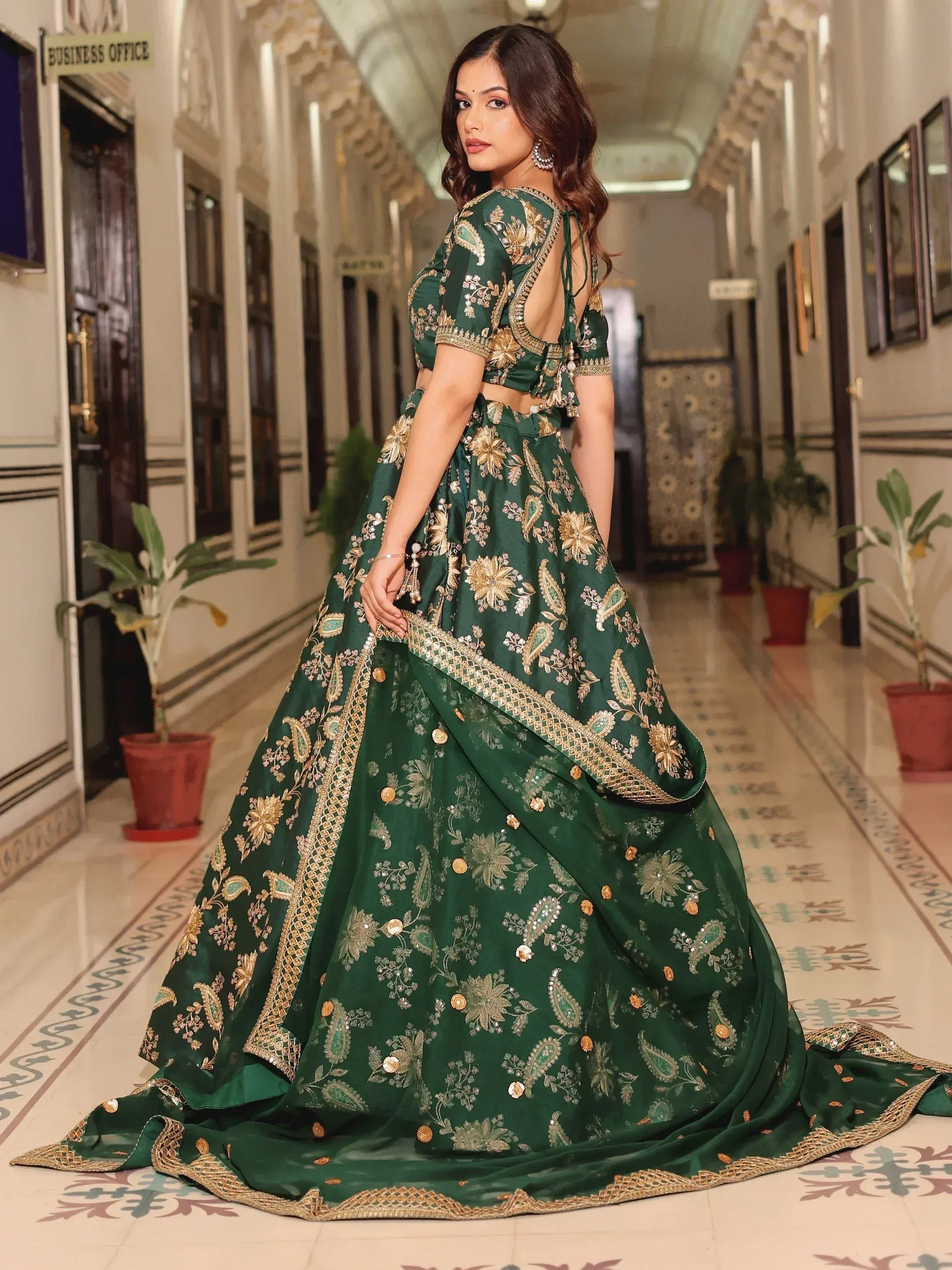 Emerald green designer lehenga choli with gold floral embroidery, perfect for Indian weddings and festive occasions.