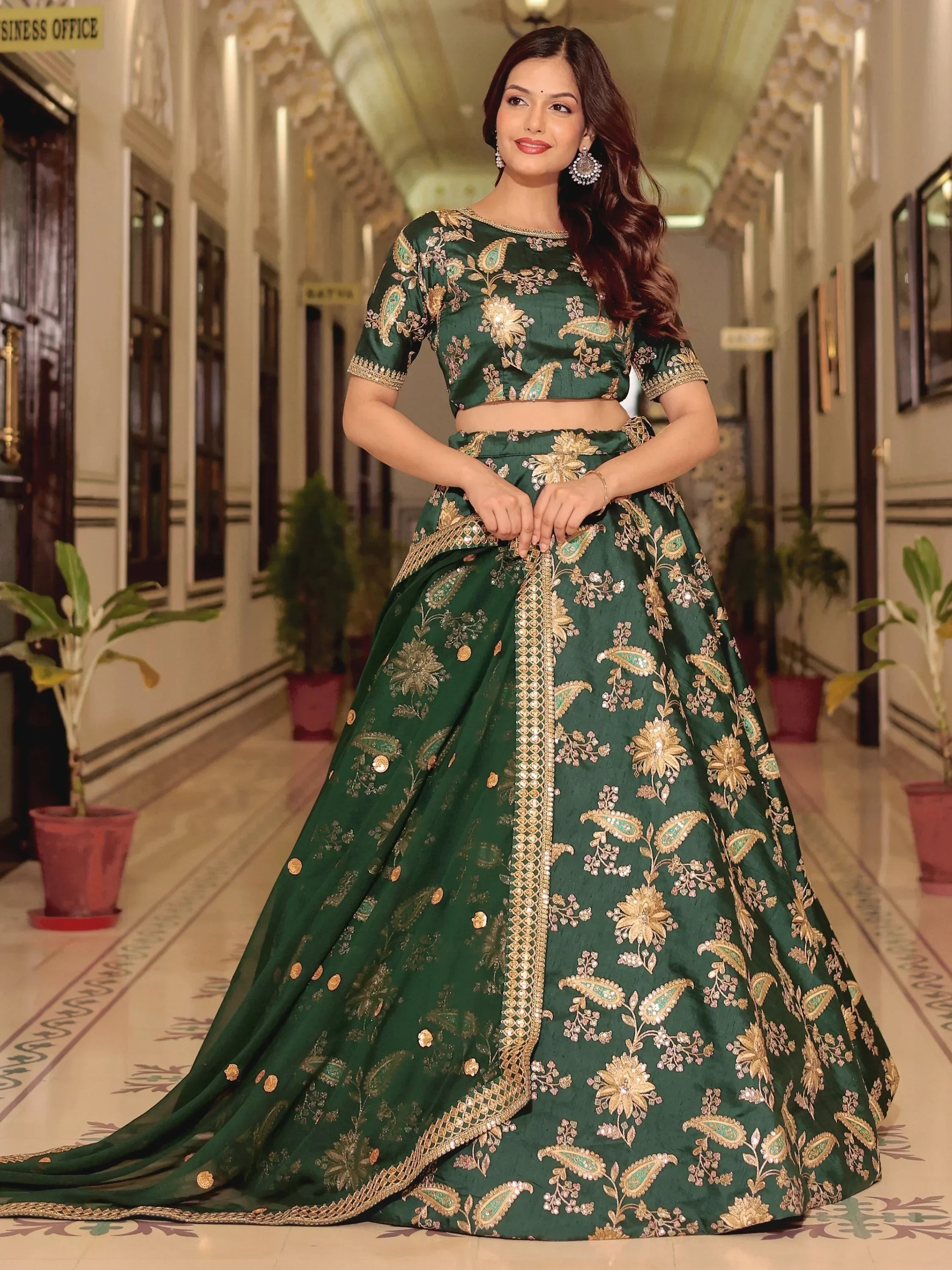 Emerald green designer lehenga choli with gold floral embroidery, perfect for Indian weddings and festive occasions.