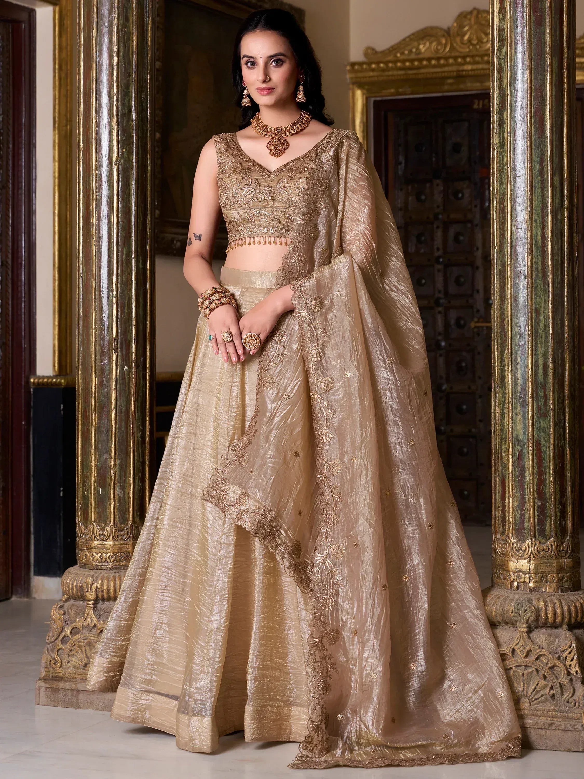 Elegant gold embroidered lehenga choli with dupatta, perfect for Indian weddings and festive occasions.