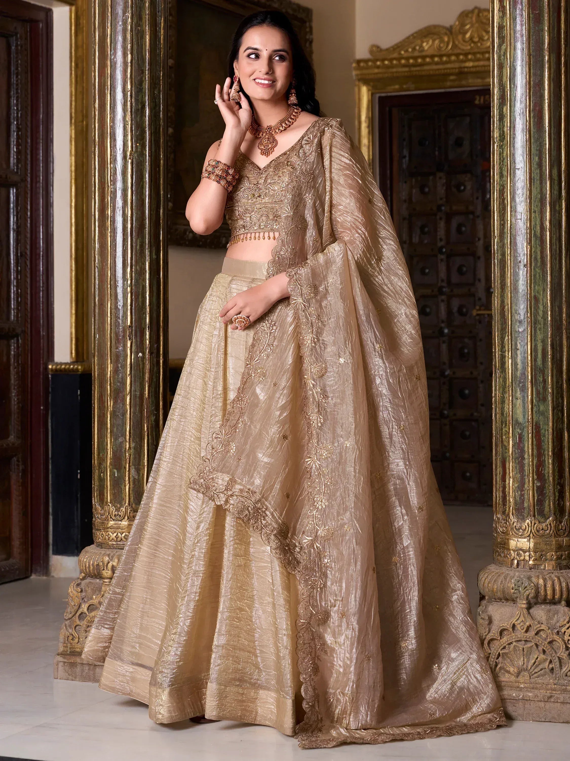 Elegant gold embroidered lehenga choli with dupatta, perfect for Indian weddings and festive occasions