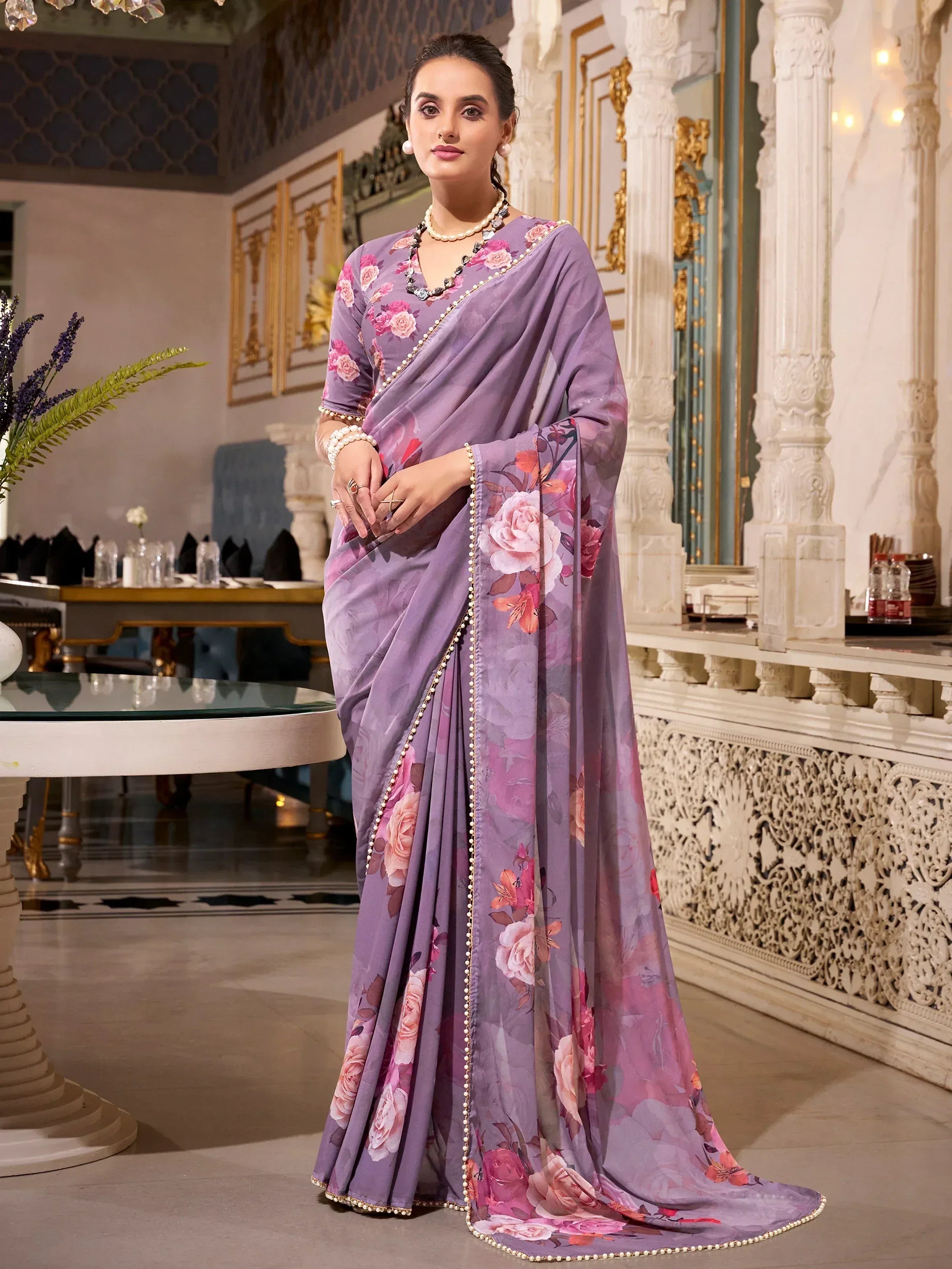 Elegant purple floral saree with pearl trim, perfect for Indian ethnic occasions and festive wear.