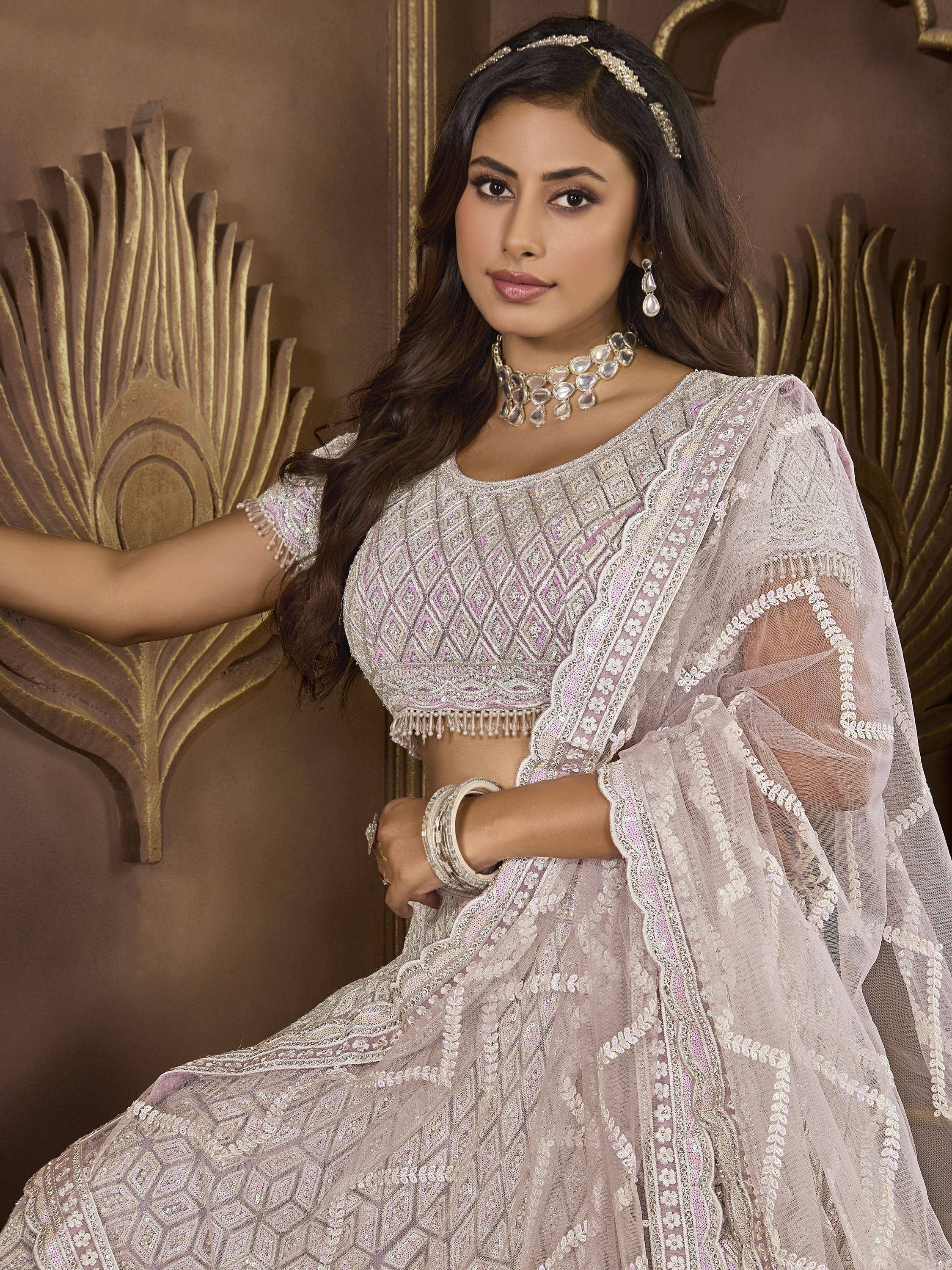 Elegant lavender lehenga choli with intricate embroidery and sequin work, perfect for Indian weddings and festive occasions.