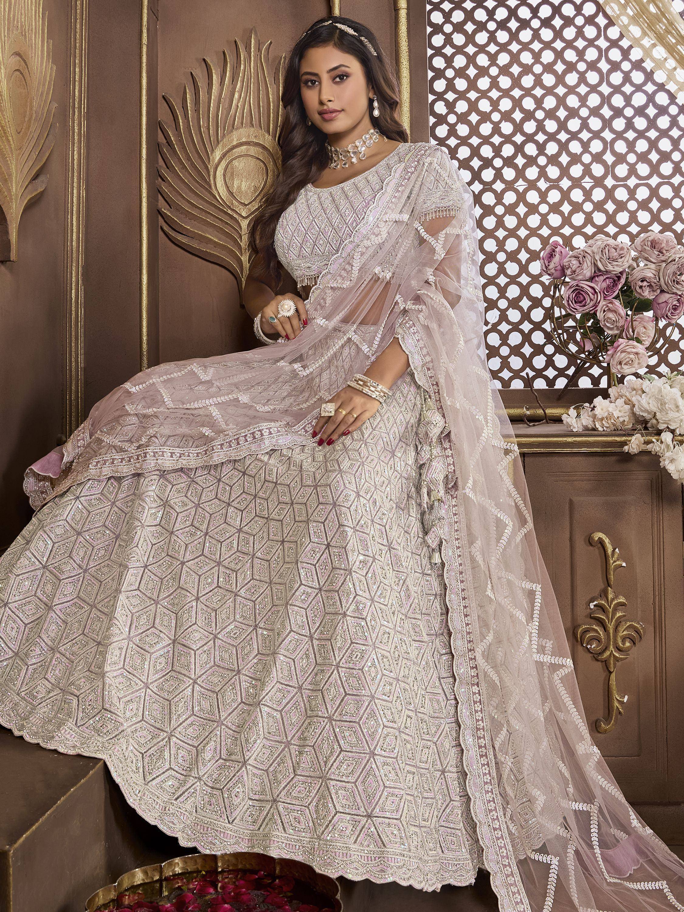 Elegant ivory lehenga choli with geometric embroidery, perfect for Indian weddings and festive occasions.