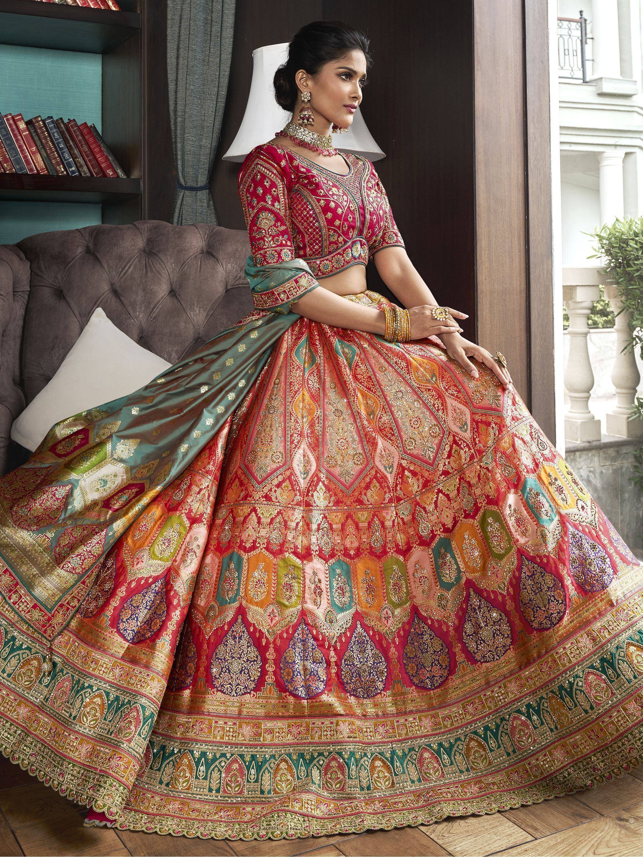 Elegant red and green designer lehenga choli with intricate embroidery, perfect for Indian weddings and festive occasions.