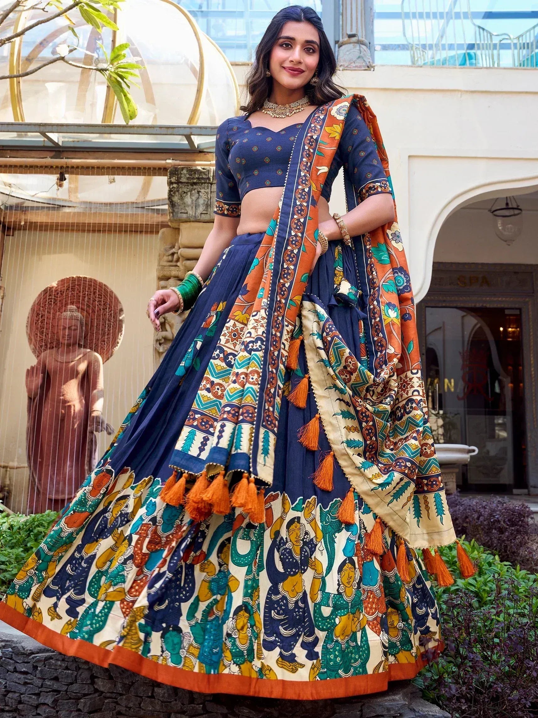 Navy blue lehenga choli with vibrant printed dupatta and tassels, perfect for Indian ethnic occasions.