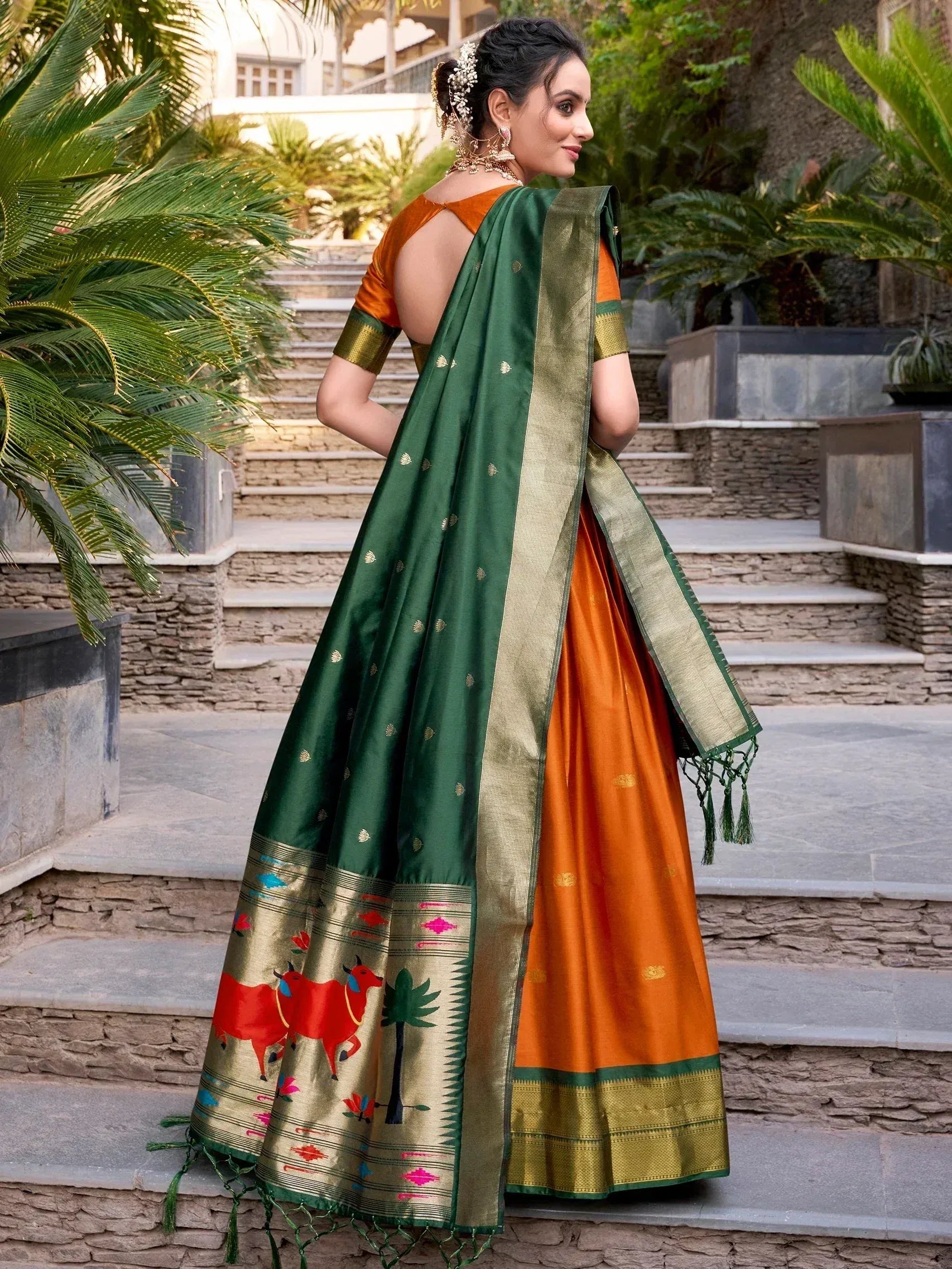 Woman in orange and green designer lehenga choli with printed dupatta, perfect for Indian ethnic occasions