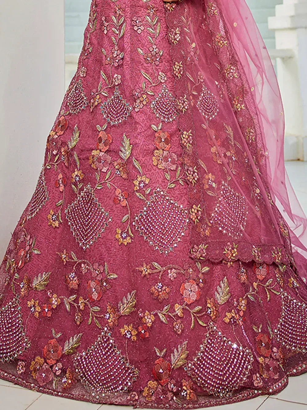 Pink embroidered lehenga with floral motifs and beadwork, perfect for Indian ethnic wear occasions.