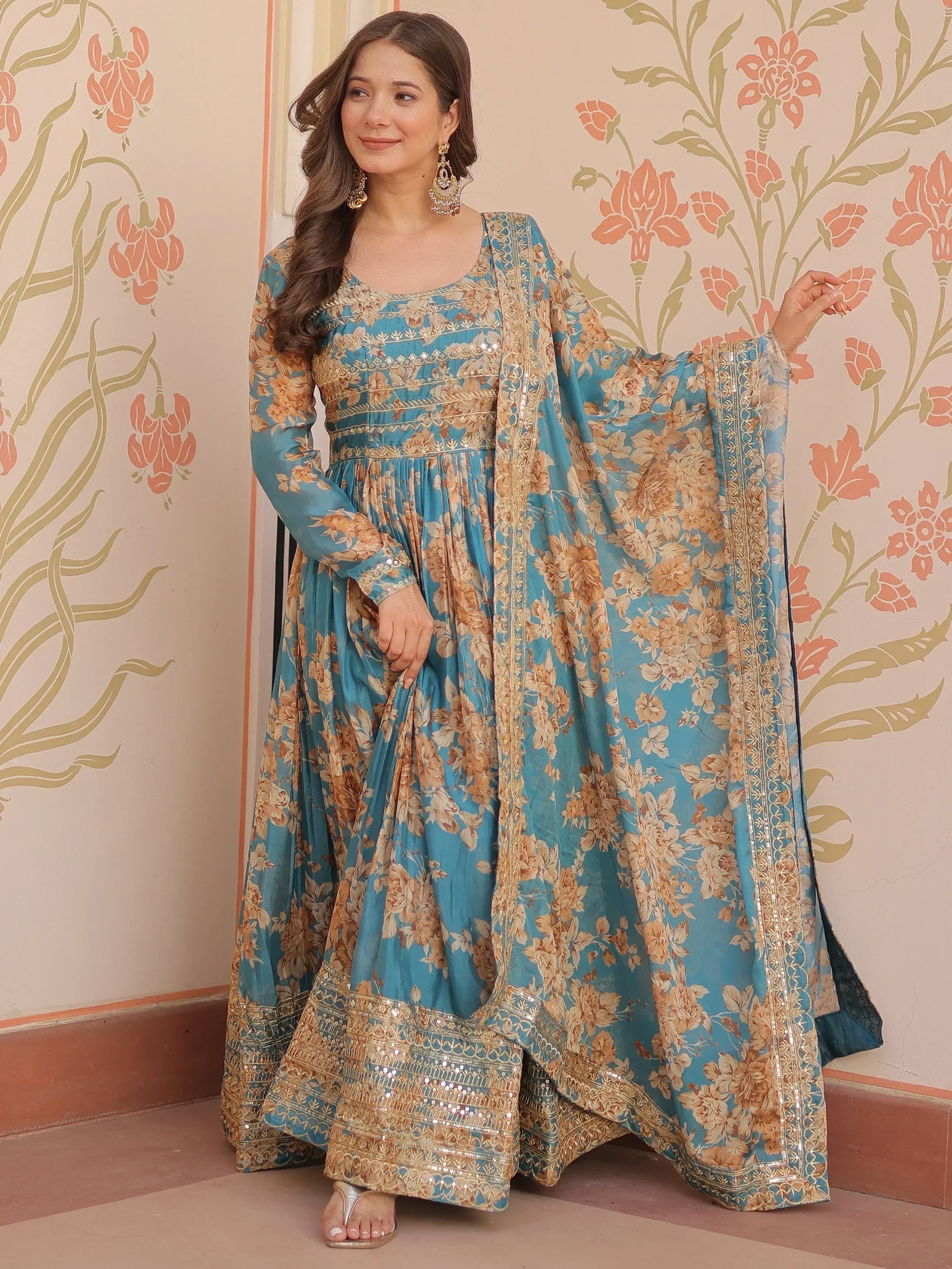 Blue floral printed ethnic gown with gold embroidery and sequin detailing, perfect for Indian occasions
