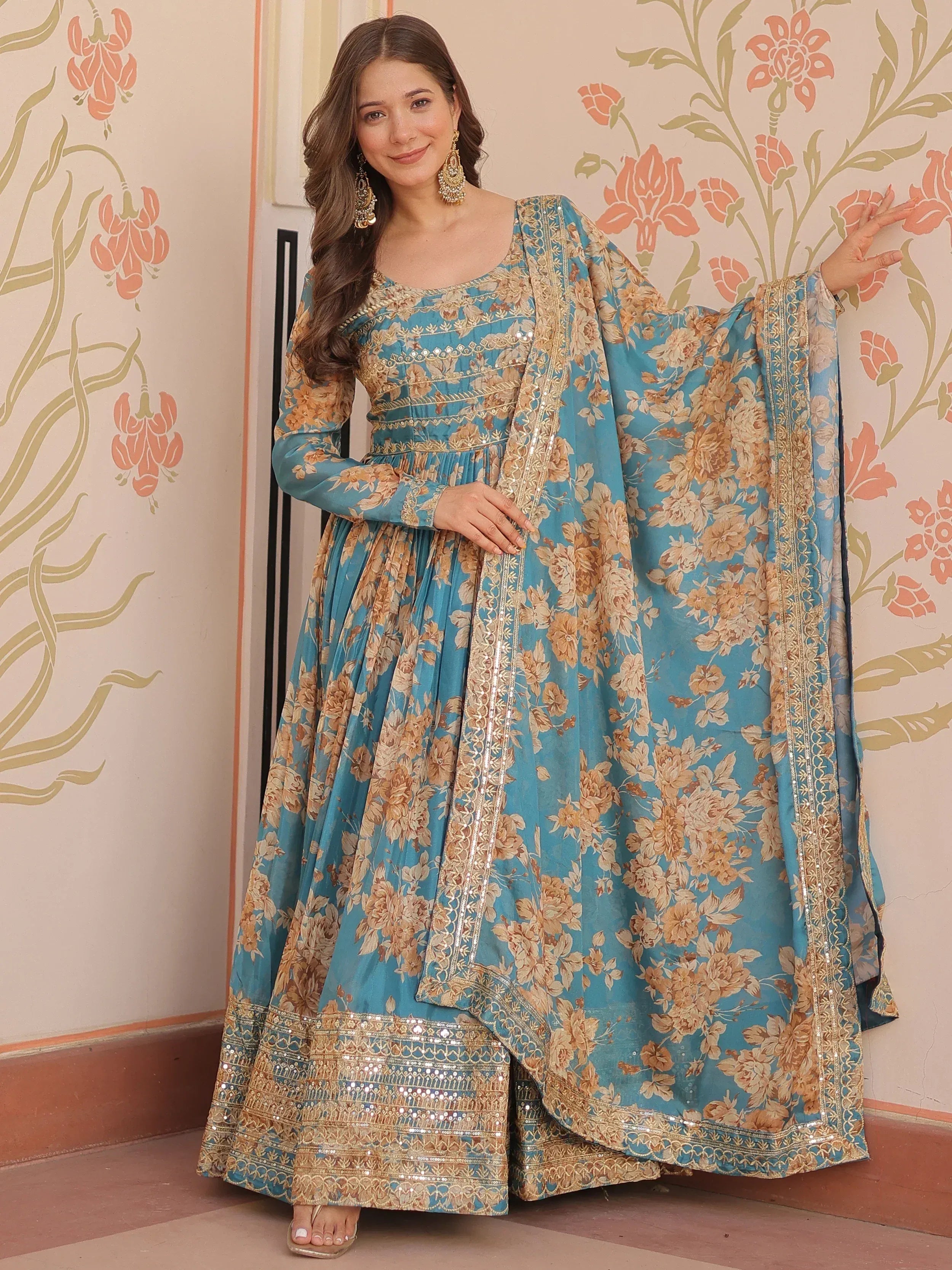 Blue floral ethnic gown with gold embroidery, perfect for Indian occasions and festive wear.