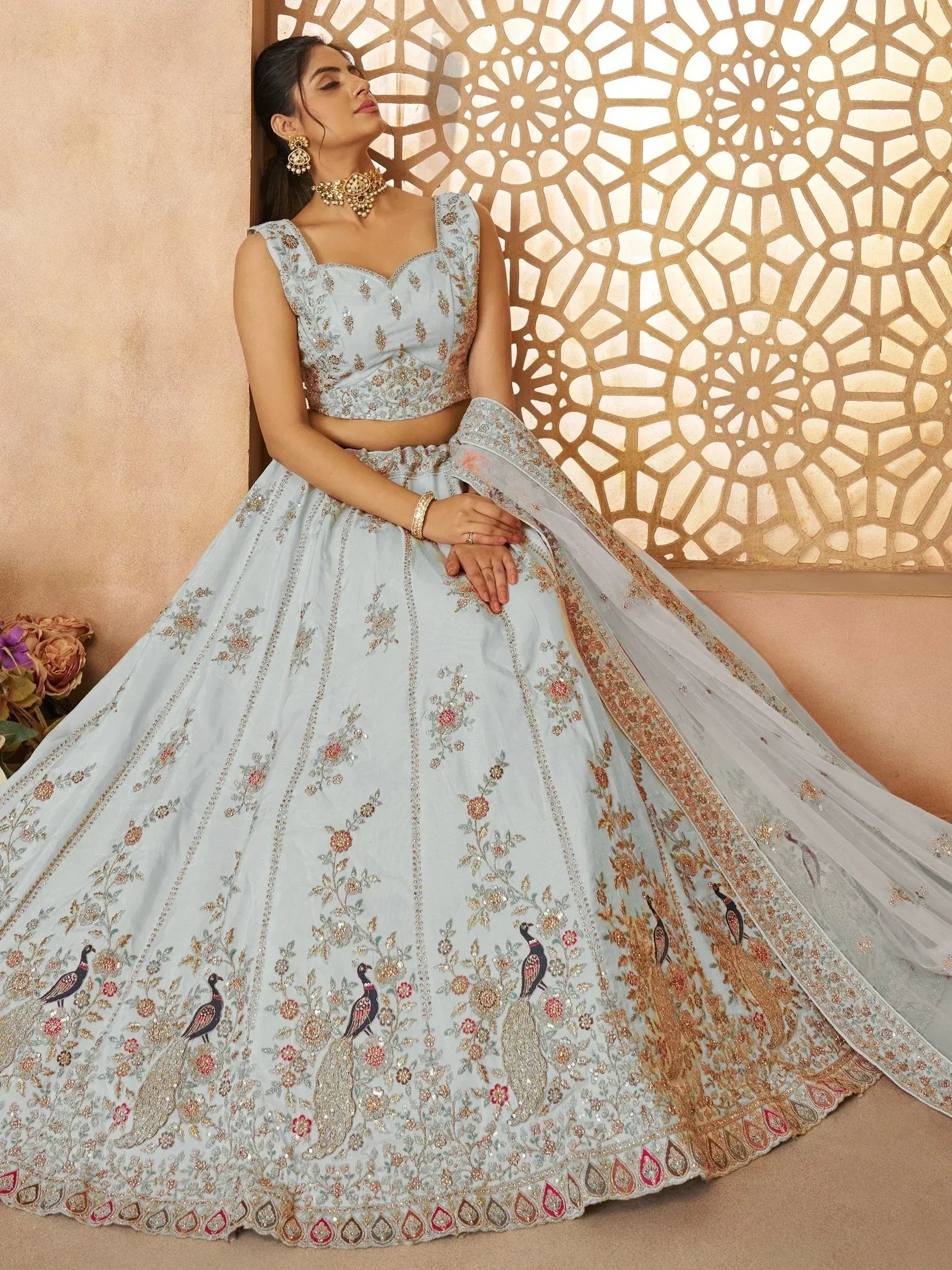 Light blue designer lehenga choli with peacock embroidery, perfect for Indian weddings and festive occasions.